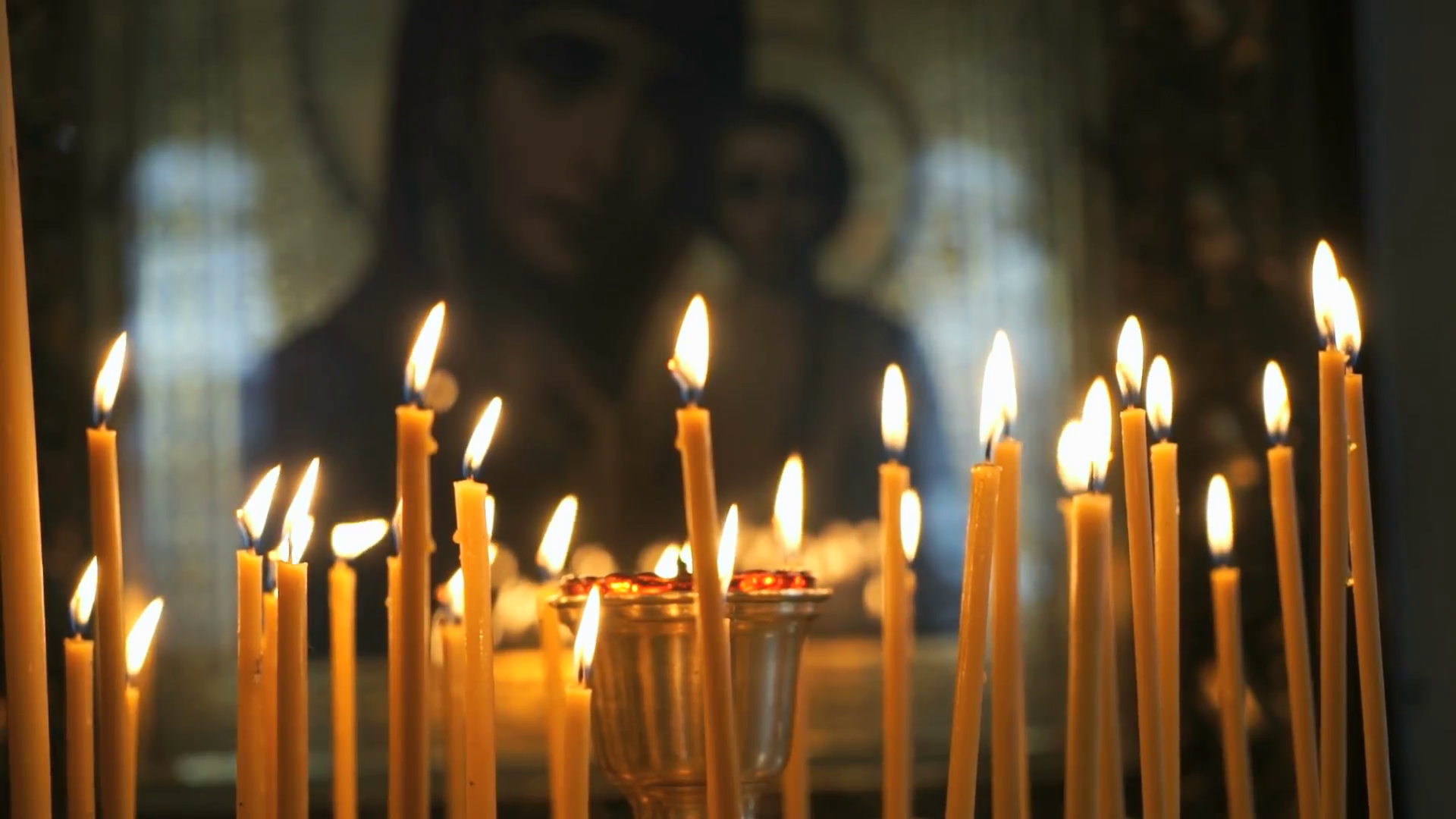 Church candles burn before the icon mother of God Stock Video ...