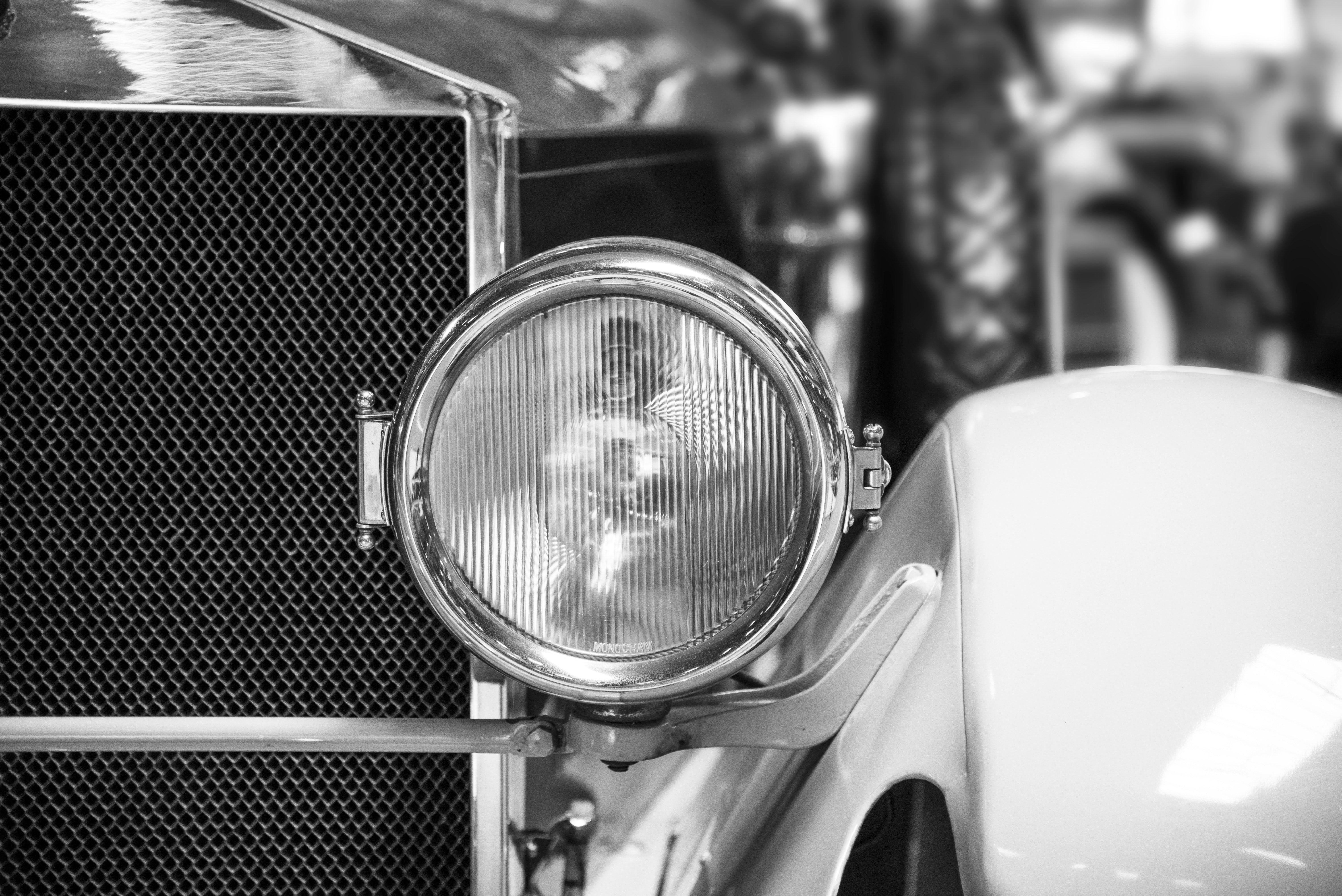 Classic car headlight grayscale photo