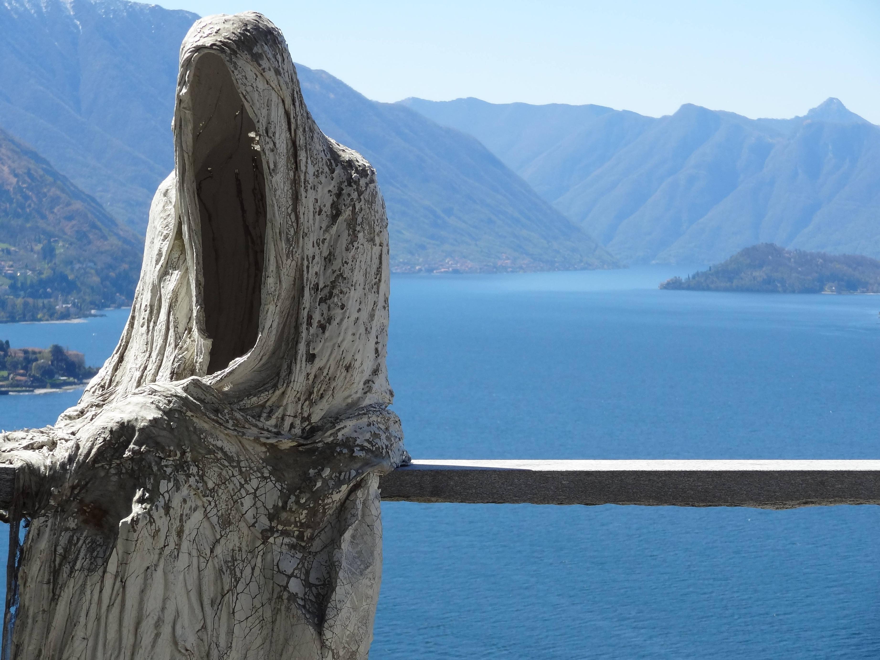 An ominous figure sitting near the cliff-side at Lake Como, Italy ...