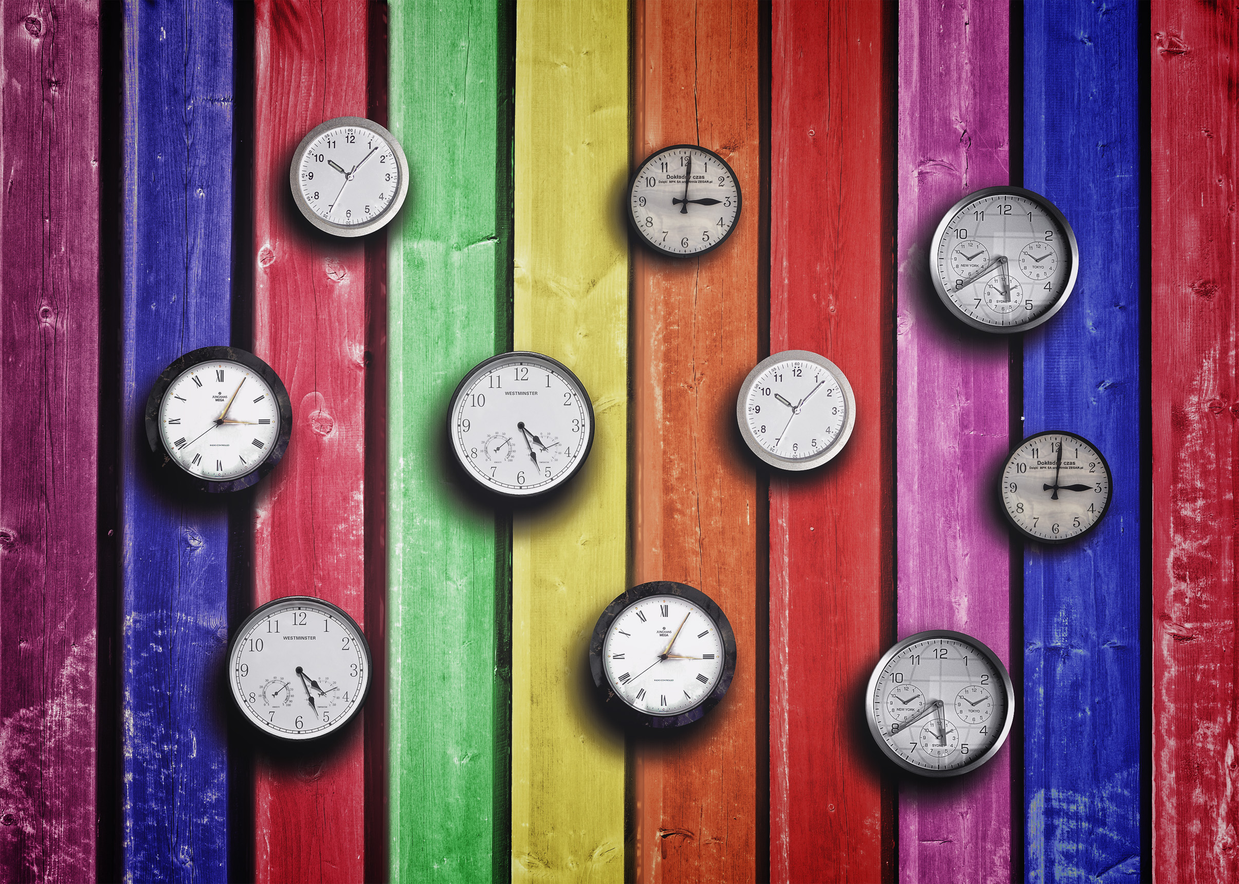 Clocks on colorful wood background - time concept photo