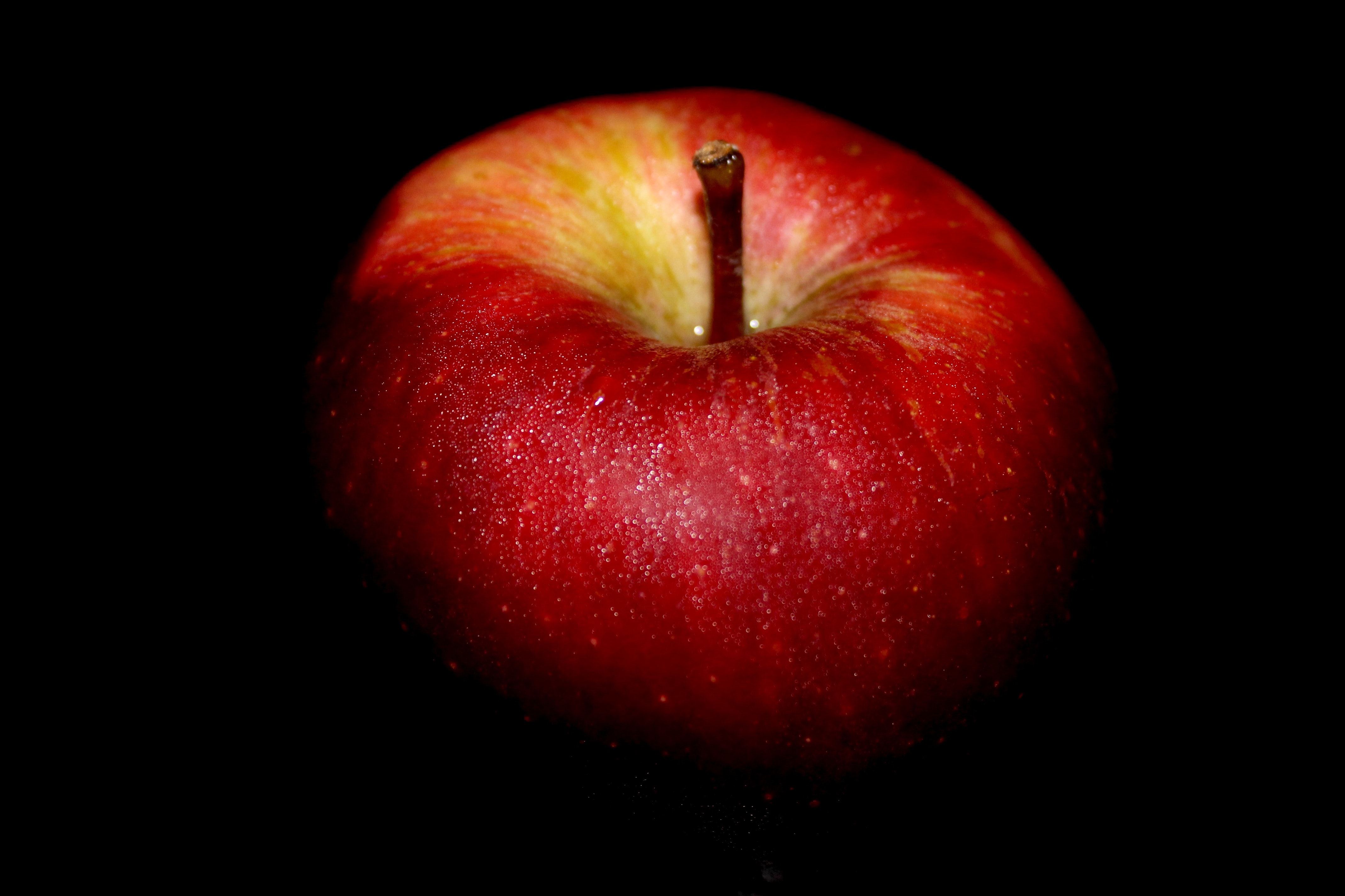 Close-up of apple against black background photo