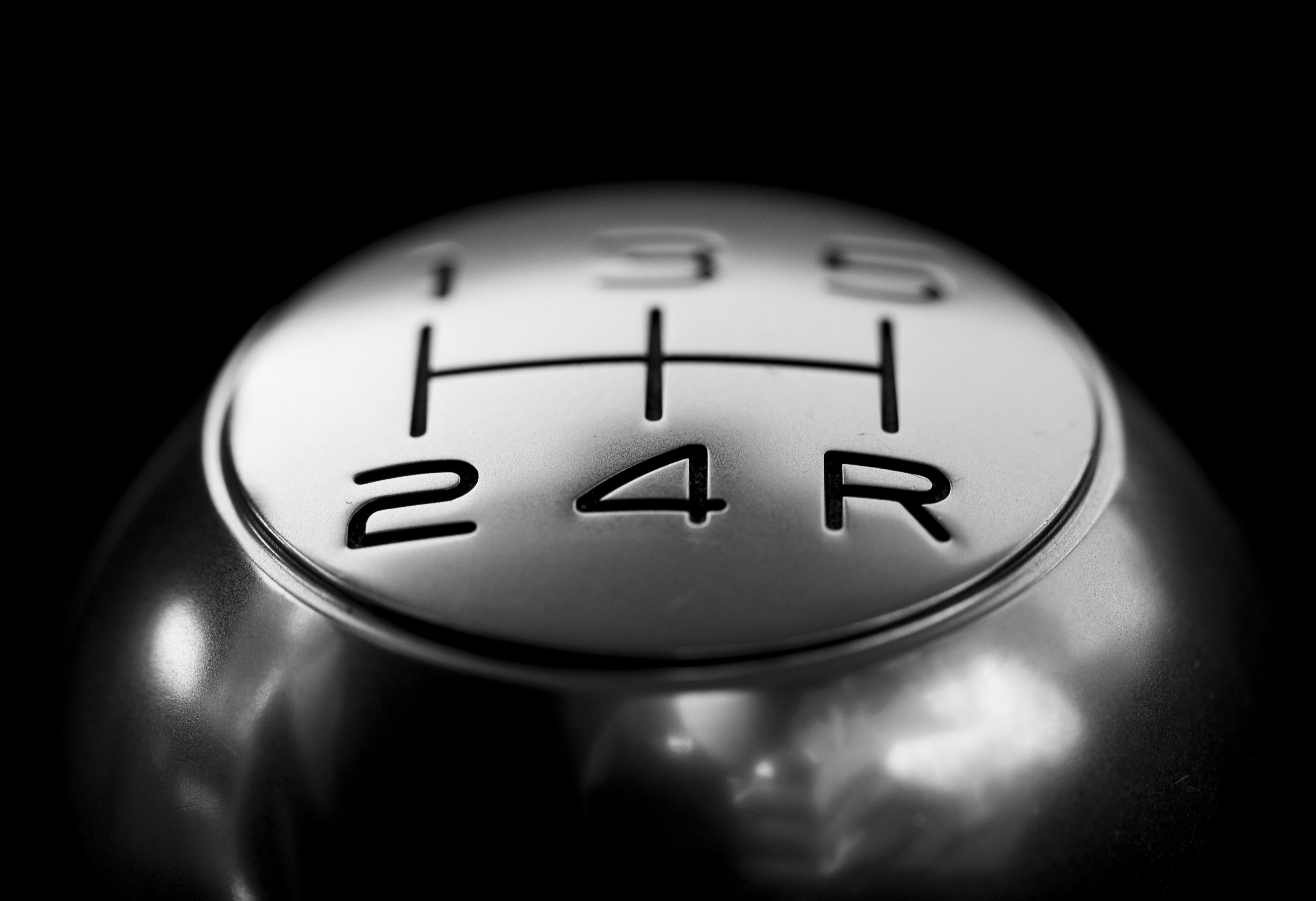 Close-up of  gear shift over black background photo