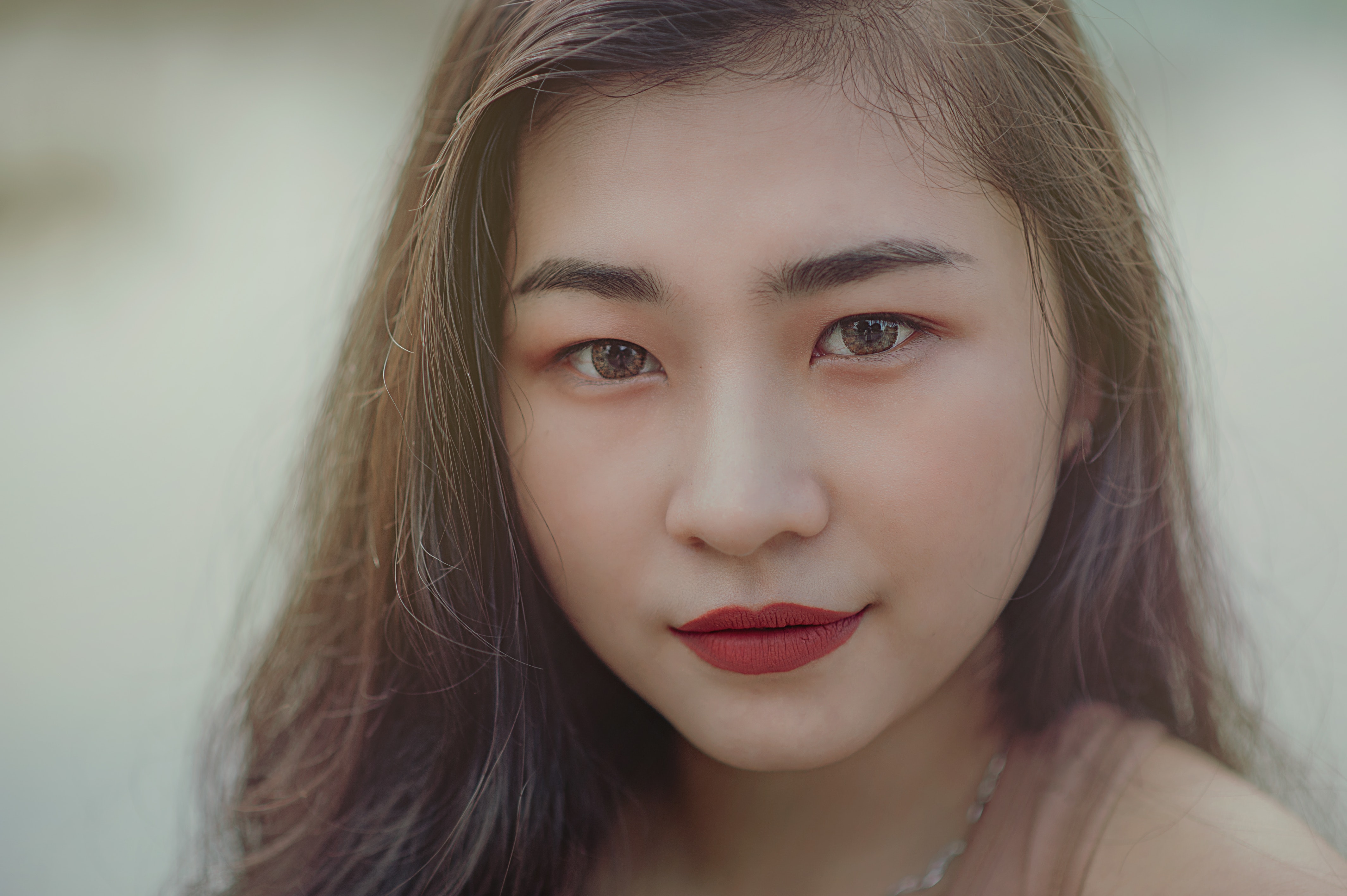 Close-up photography of woman wearing red lipsticks