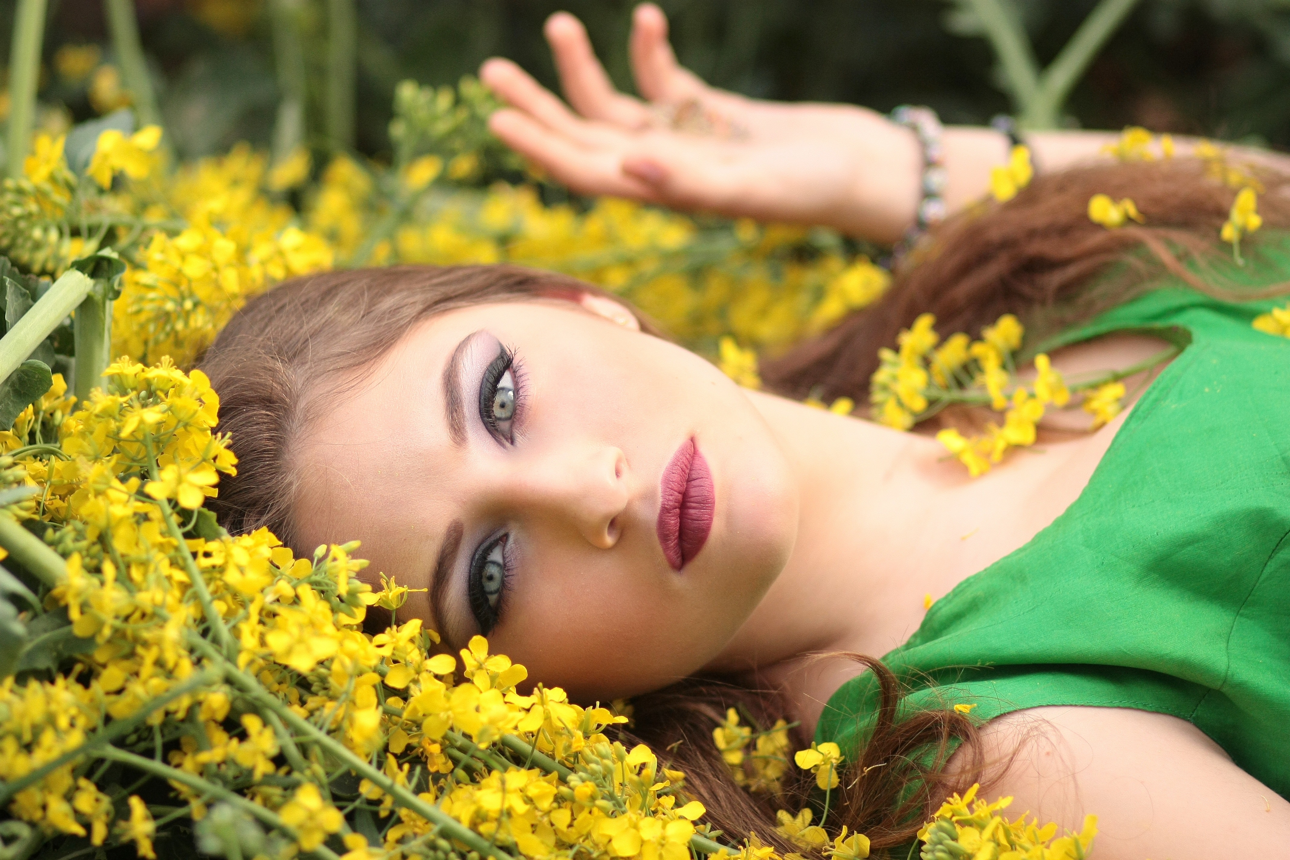 Close-up portrait of young woman with yellow flowers photo