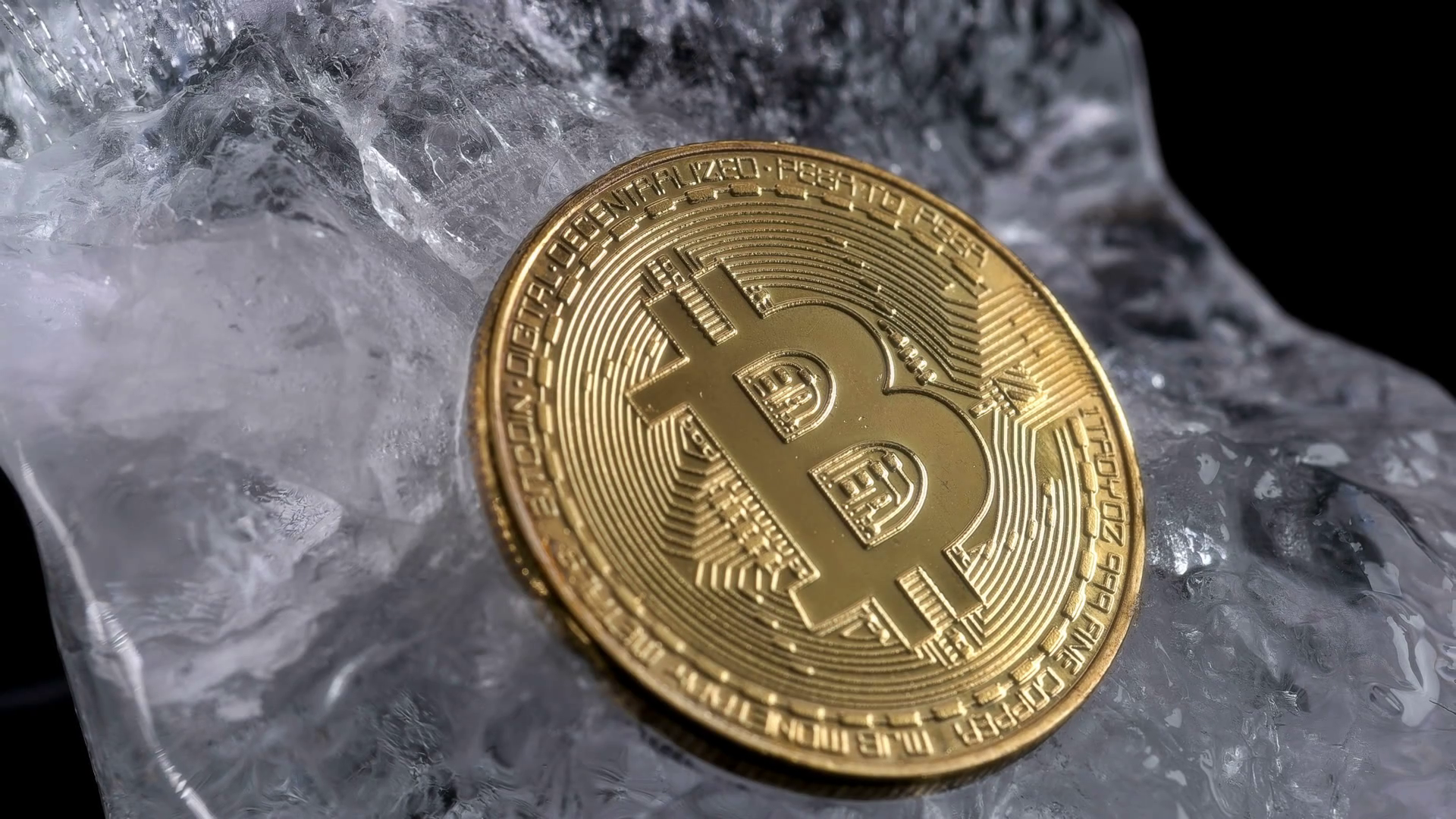 Coin, bitcoin frozen in transparent ice, close-up, slowly spinning ...