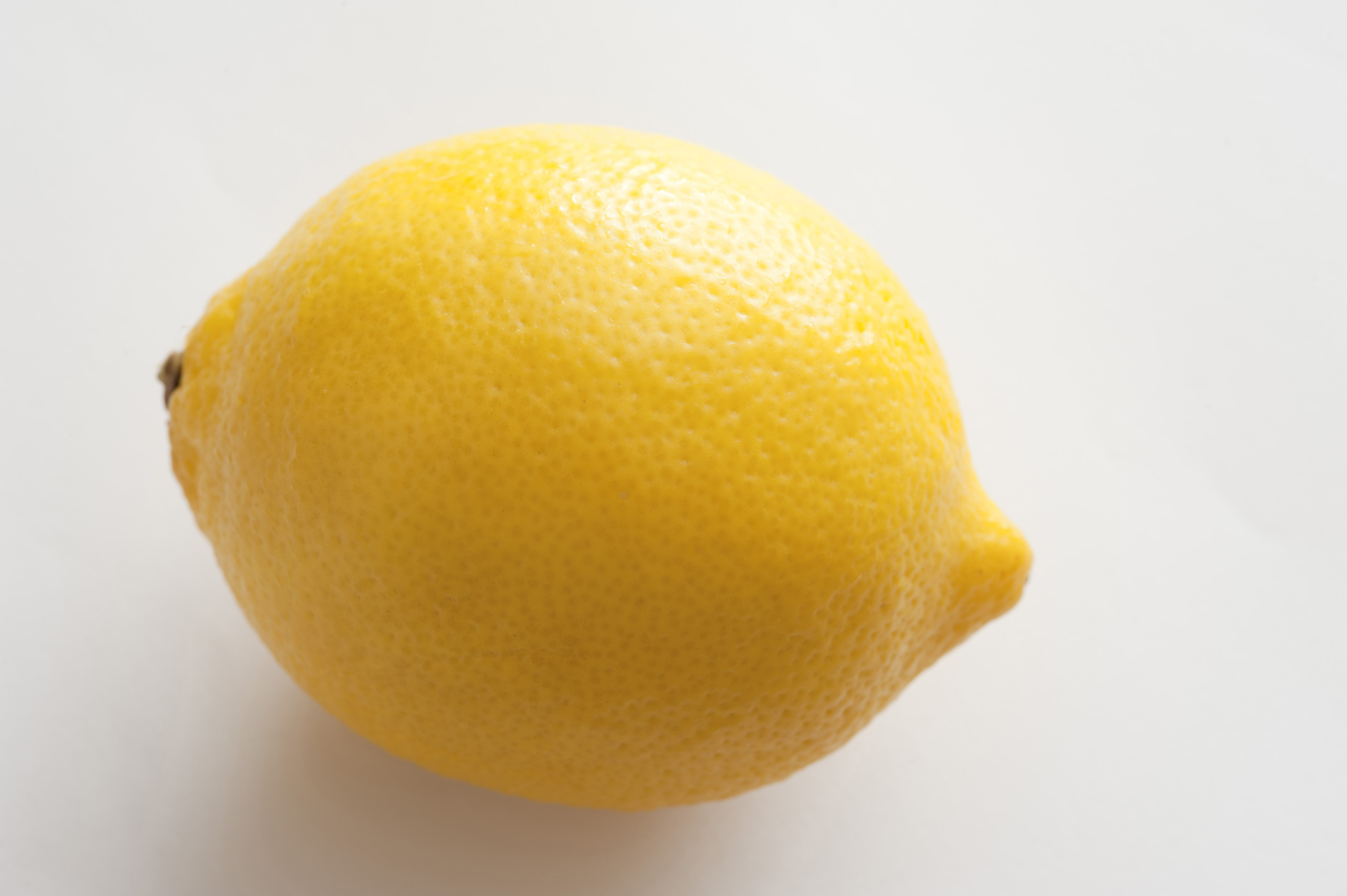Close-up of yellow lemon on white background - Free Stock Image