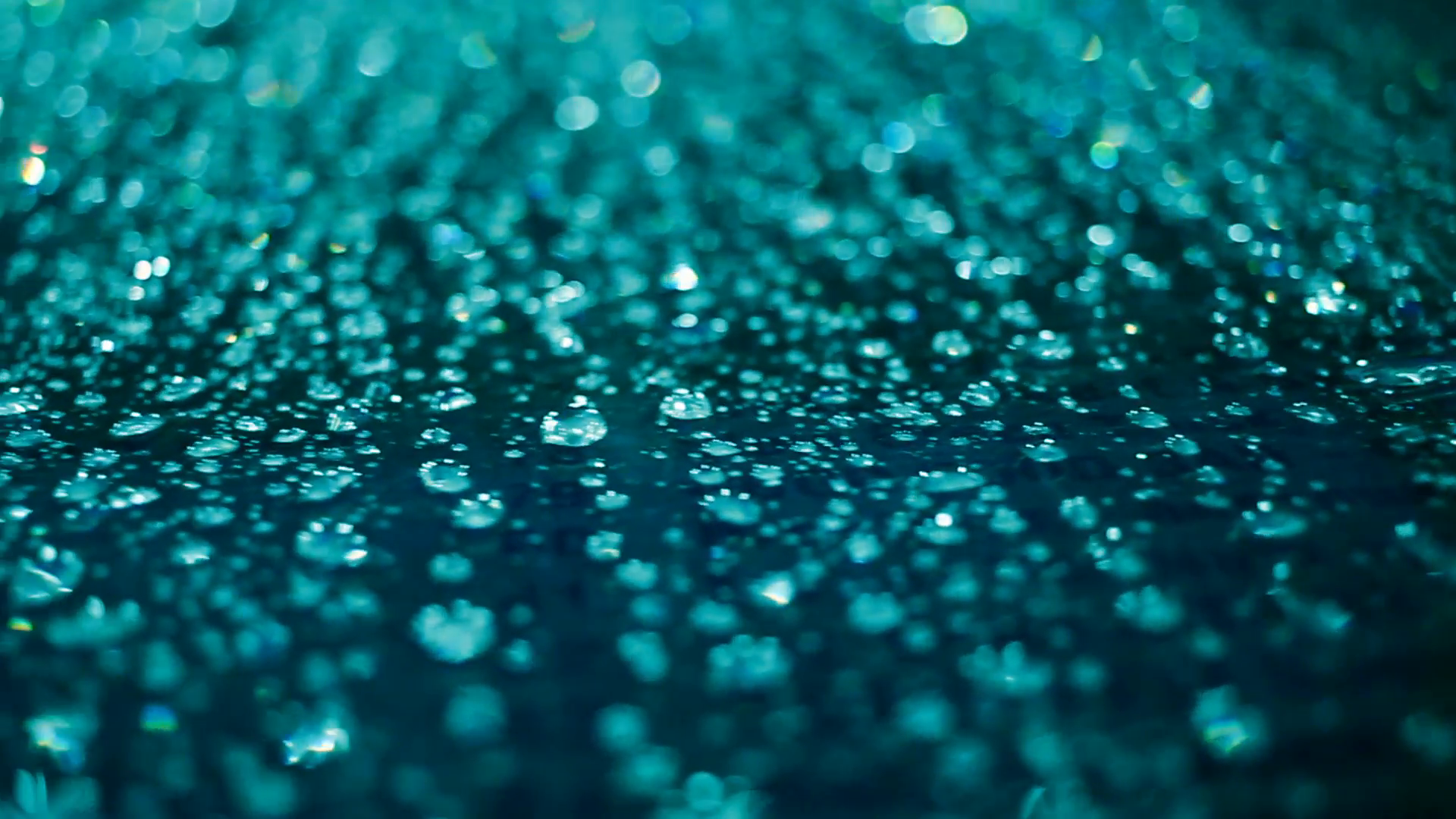 Droplets on glass at night. Closeup of water drops on glass after ...