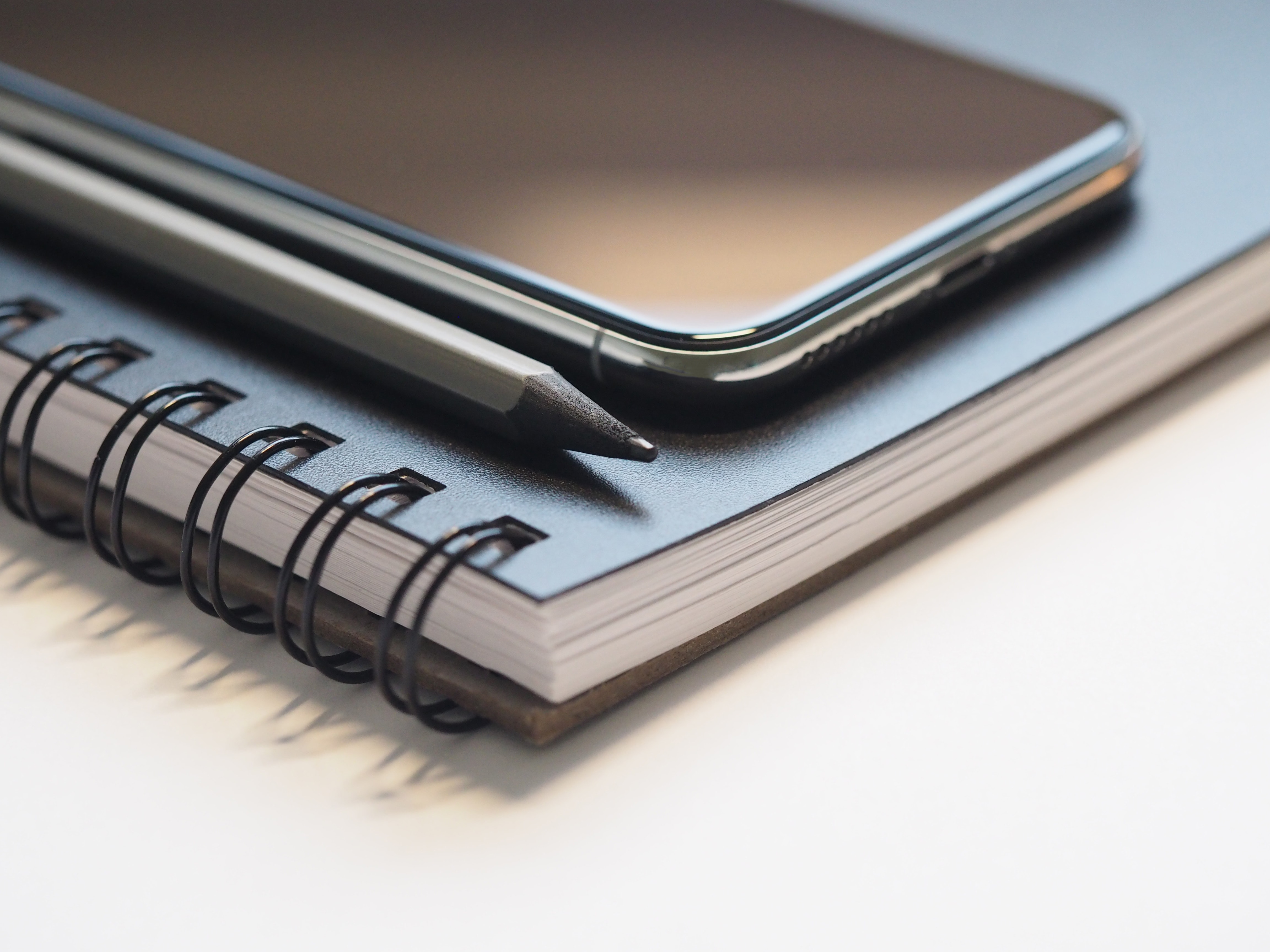 Closeup Photo of Black Smartphone Near Black and Grey Pencil on Black Spiral Notebook, Black, Research, Work desk, Work, HQ Photo