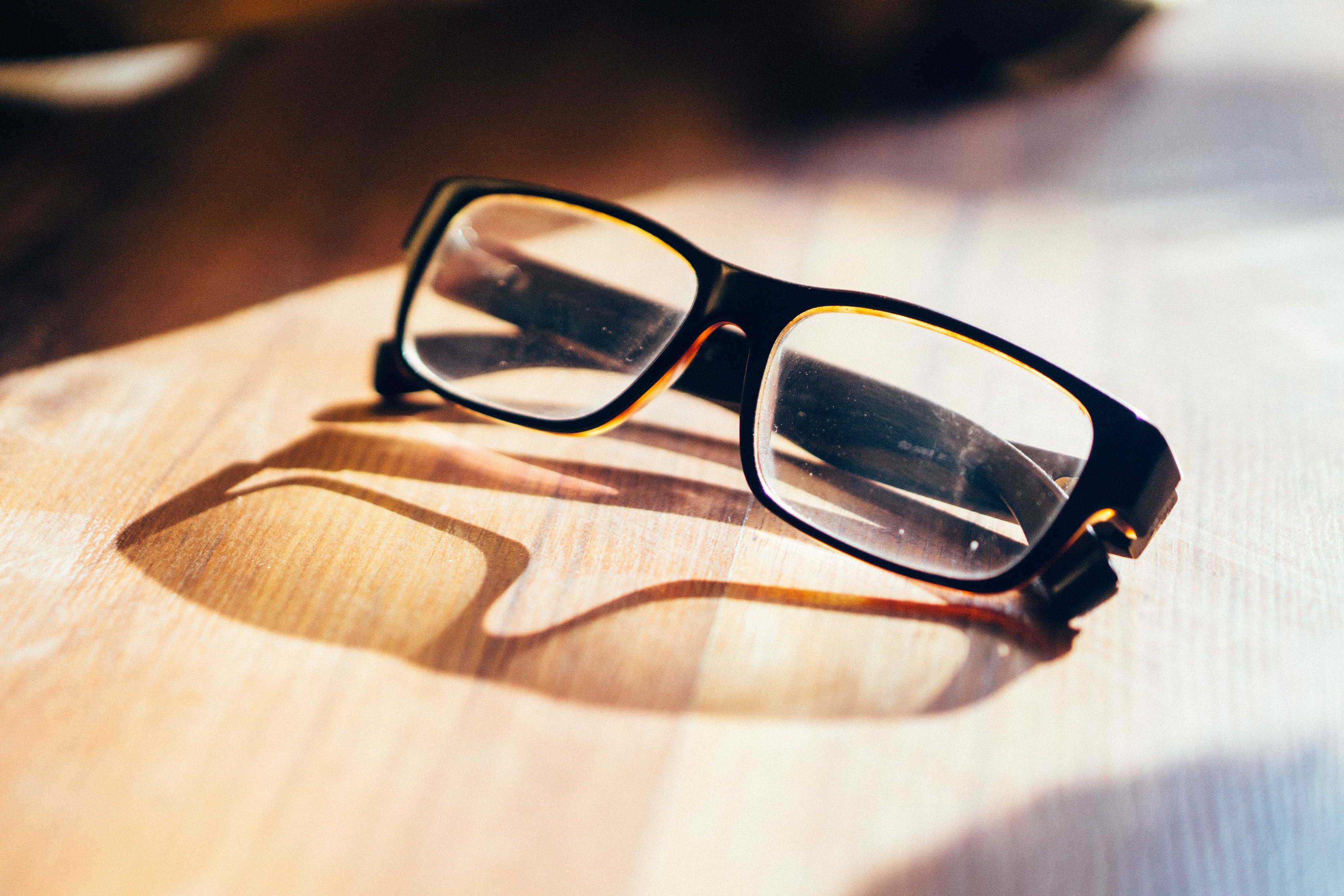 Close-up Photography of Eyeglasses at Golden Hour · Free Stock Photo