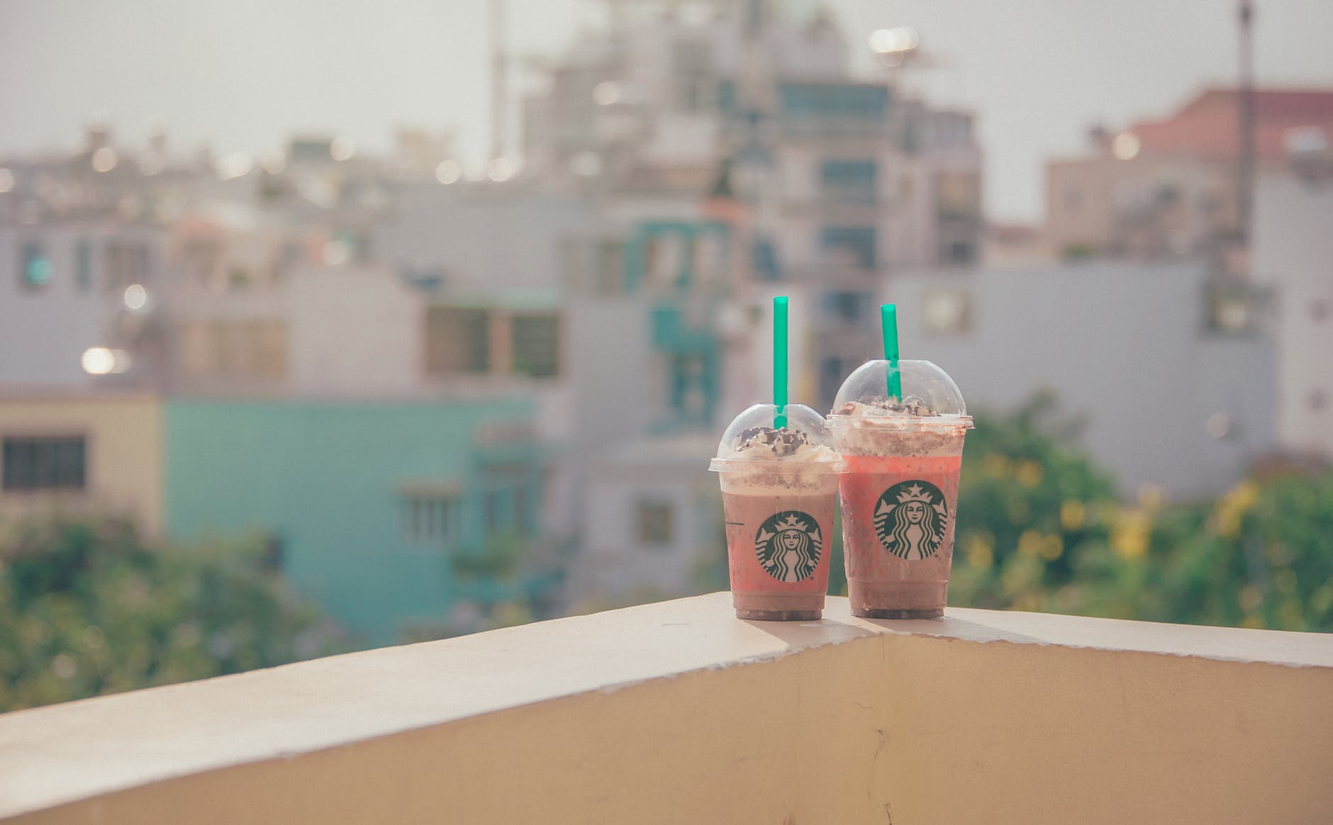 Close-up photography of two starbucks disposable cups