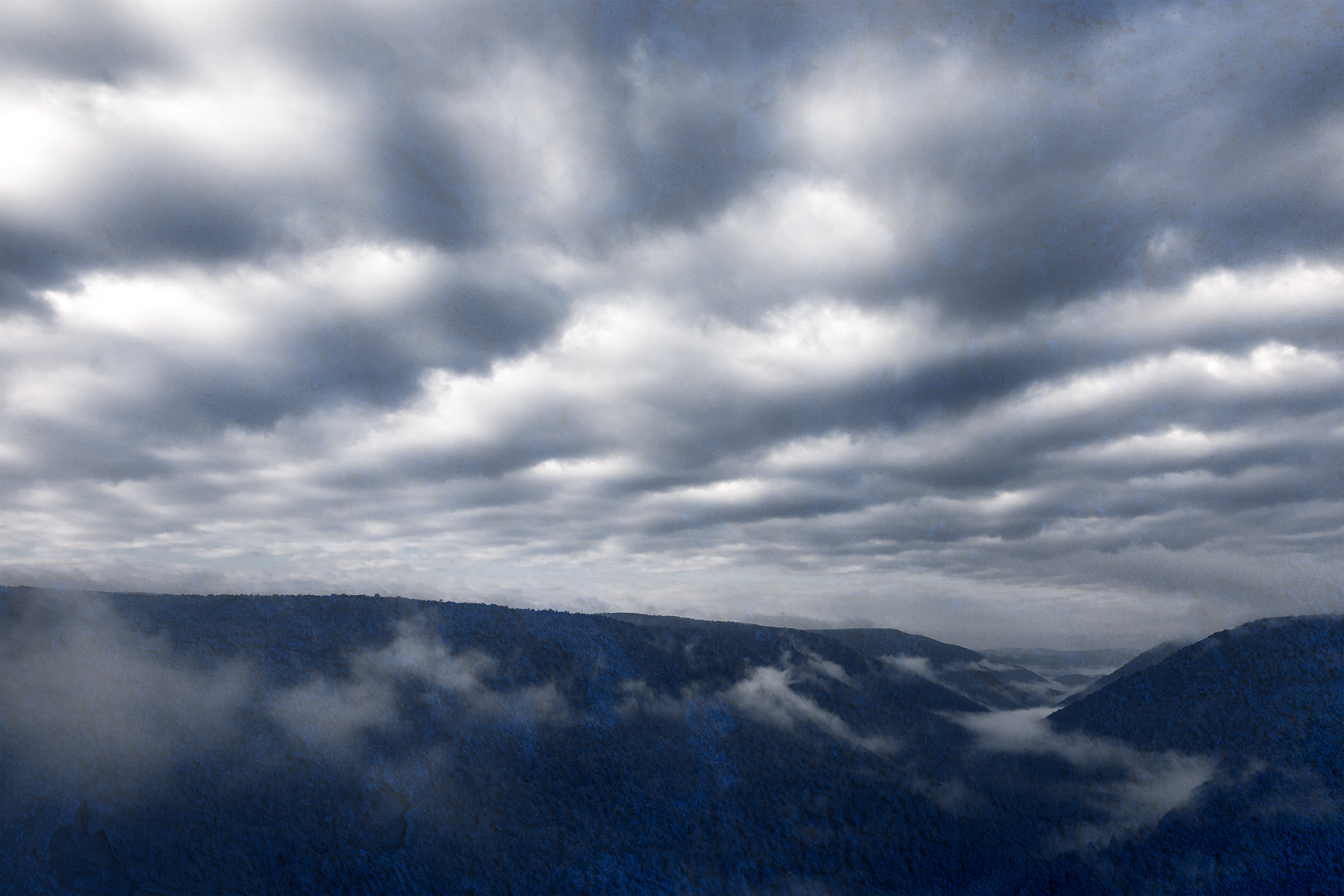 Cloudy mountain fog - blue grunge photo