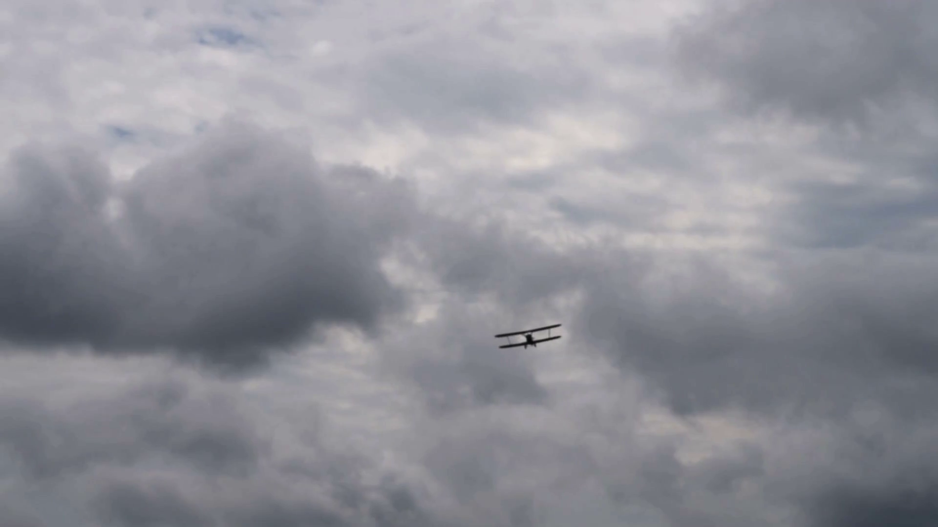 Old plane flying in dull cloudy sky. Retro airplane black silhouette ...