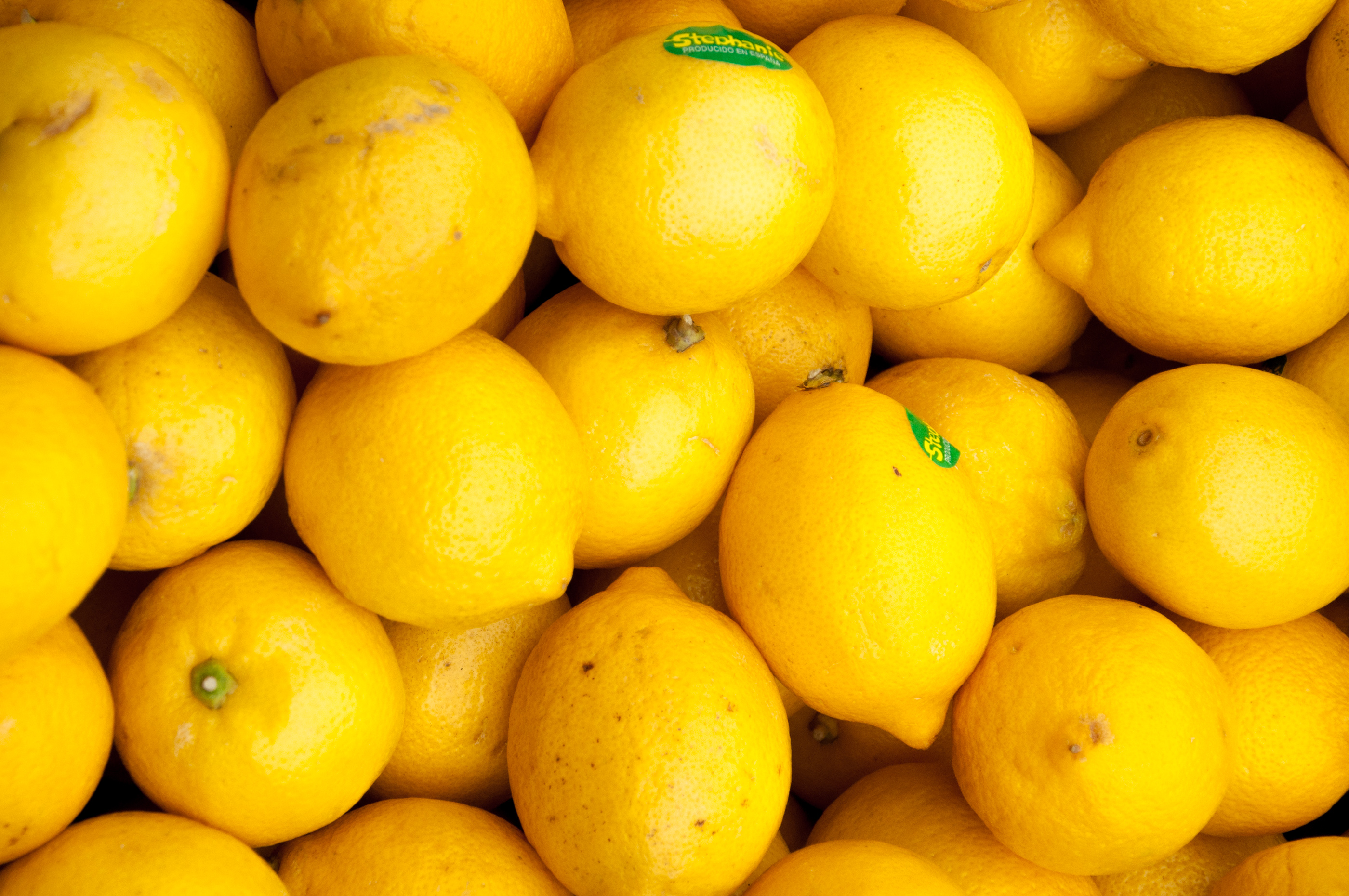 Colorful display of lemons in market photo