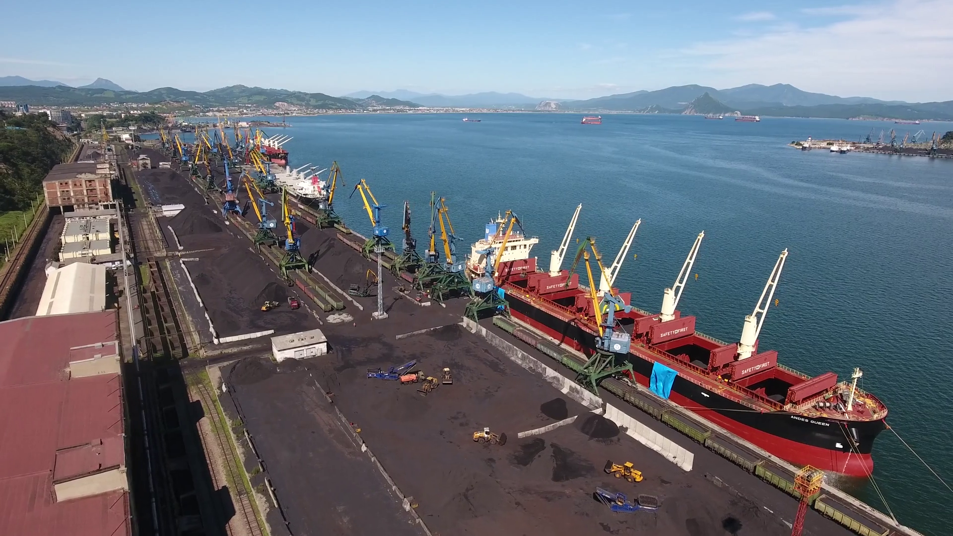 Aerial drone flight over large black coal commercial industrial port ...