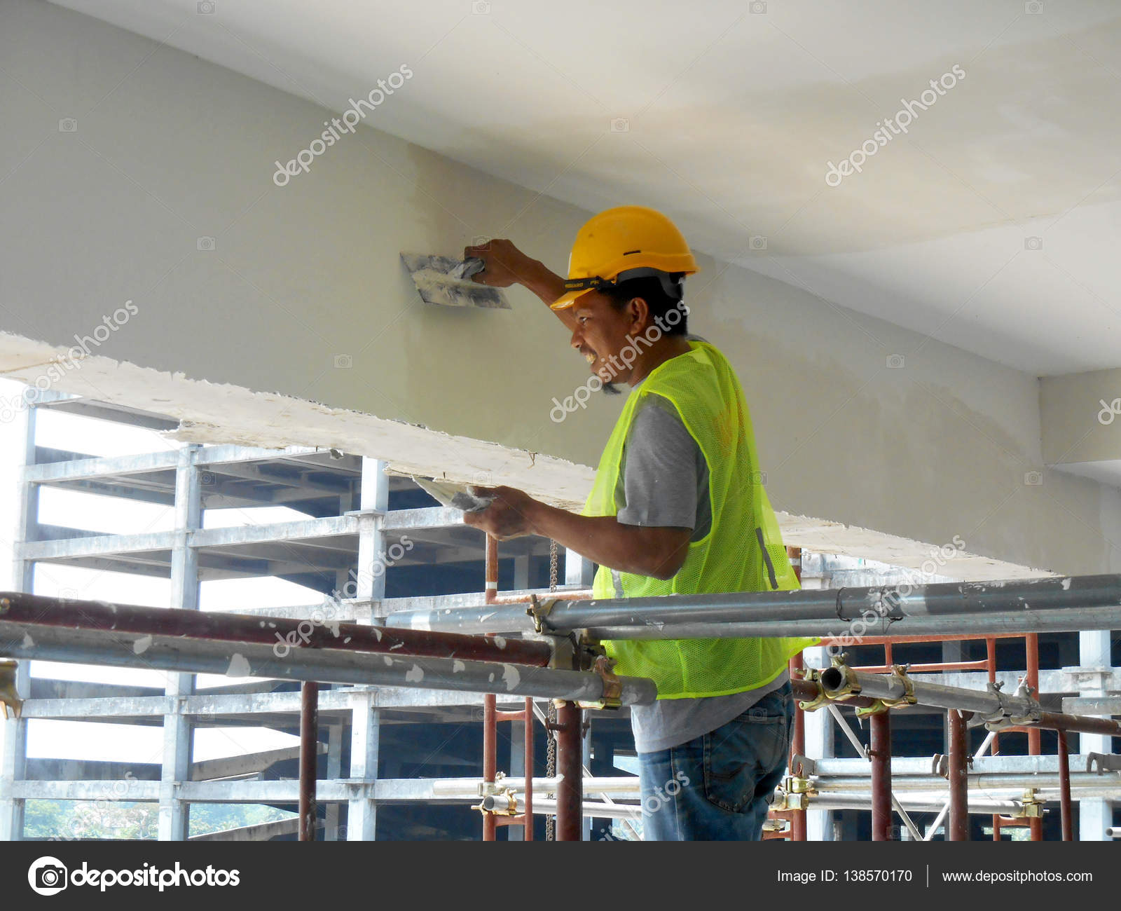 Construction site workers are doing concrete ceiling soffit skim ...