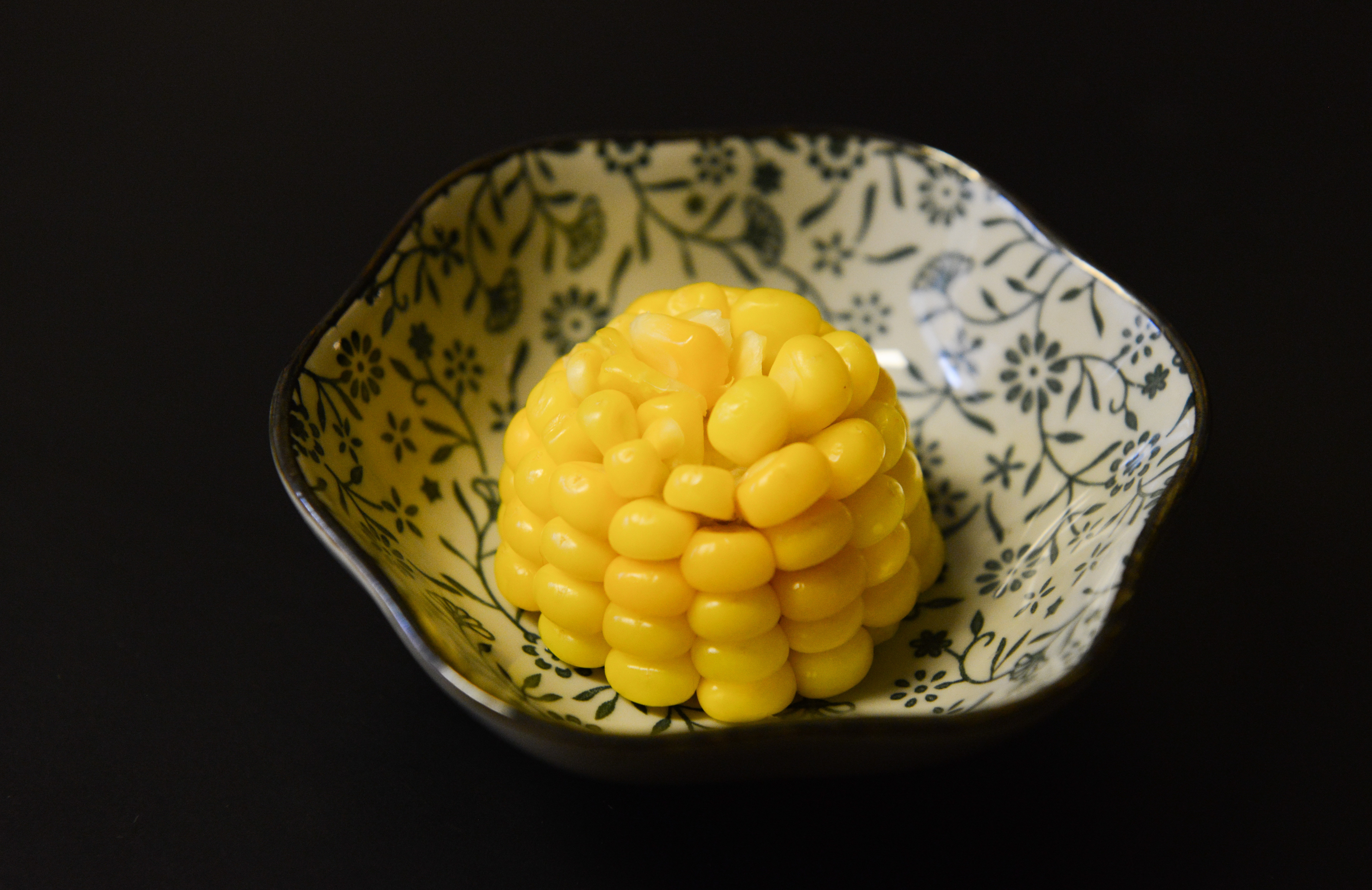 Cooked corn on bowl photo