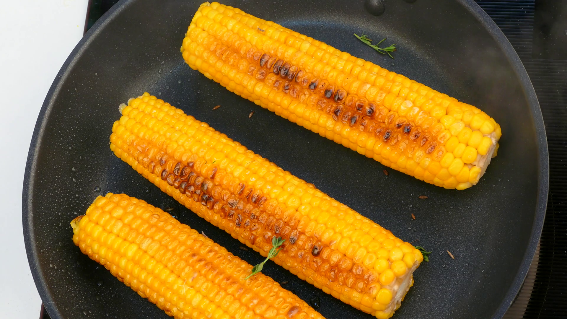 turn the cooked corn cobs in a frying pan Stock Video Footage ...