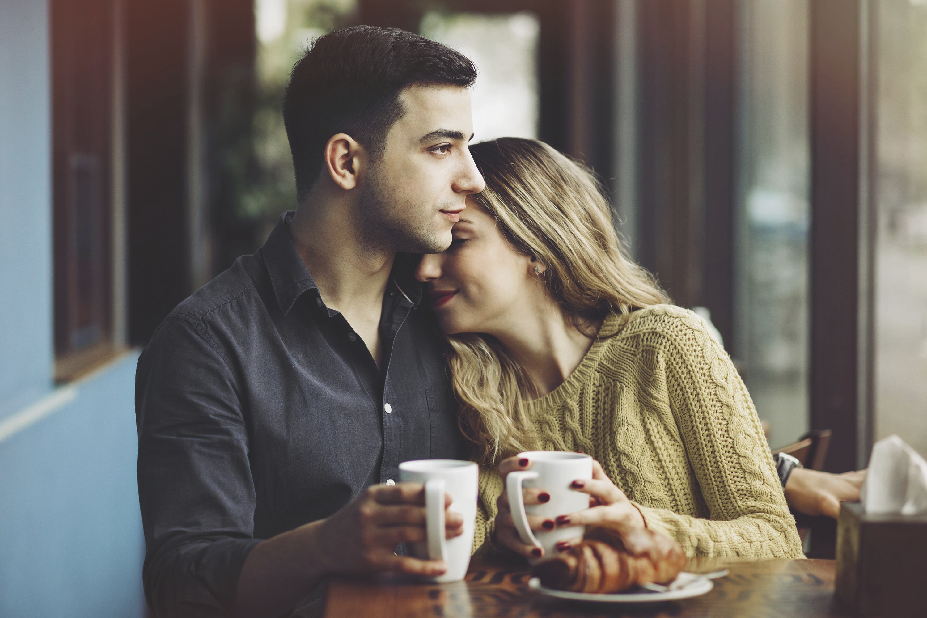 Couple in love drinking coffee in coffee shop | Author Love