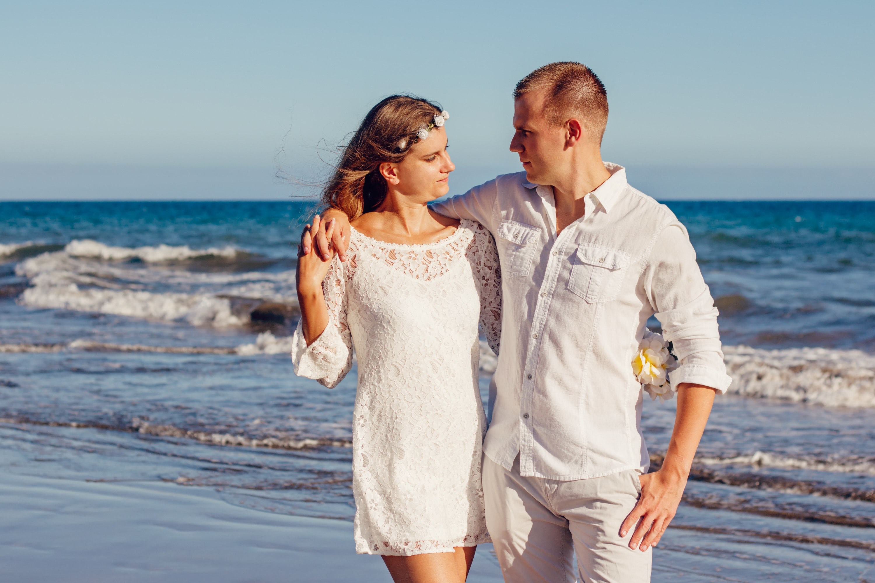 Couple looking at each other beside beach photo