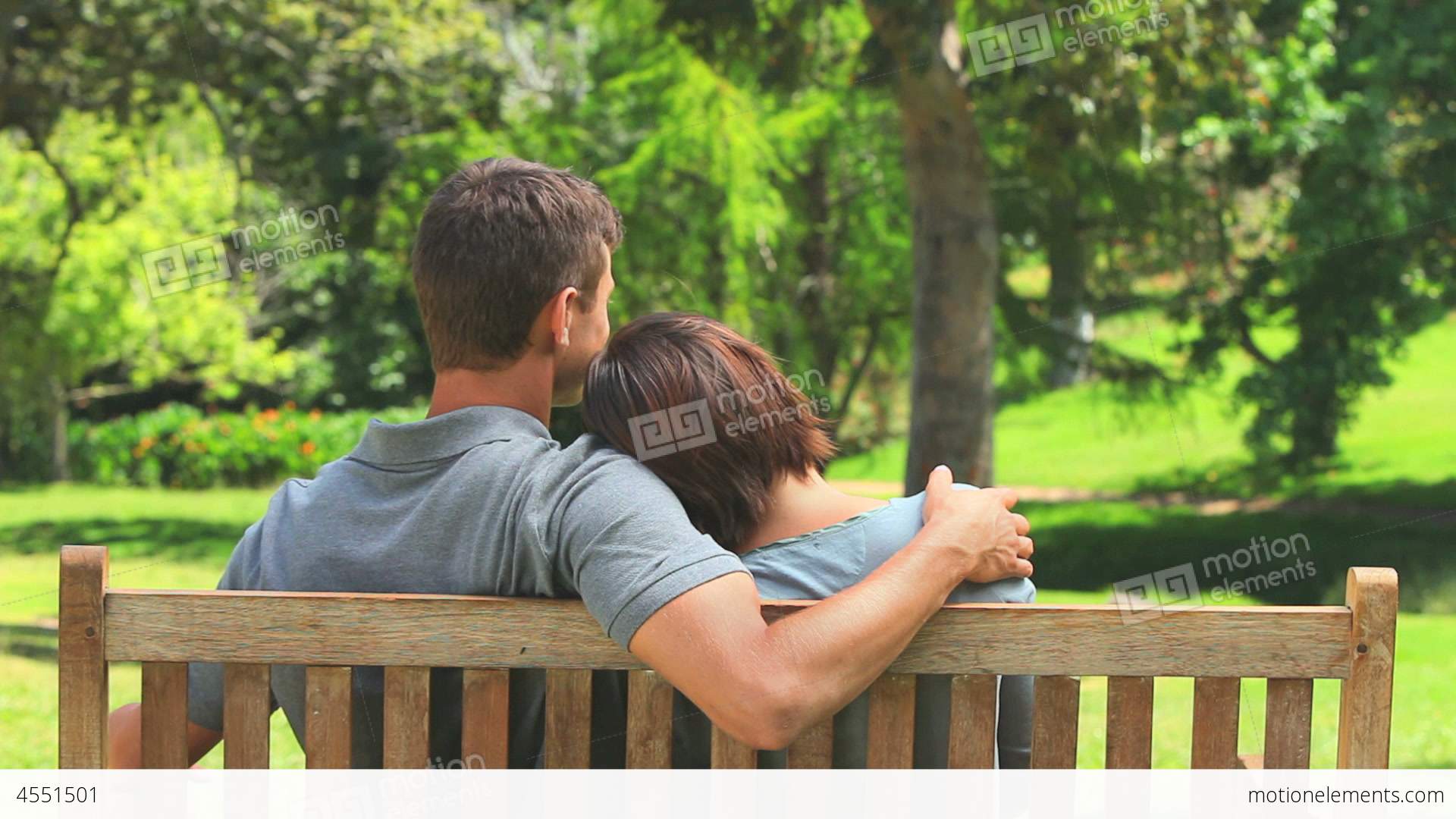Loving Young Couple Sitting On A Bench Stock video footage | 4551501