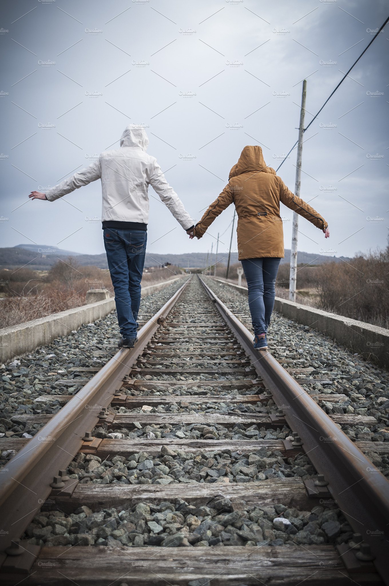 Girl walking on train tracks ~ People Photos ~ Creative Market