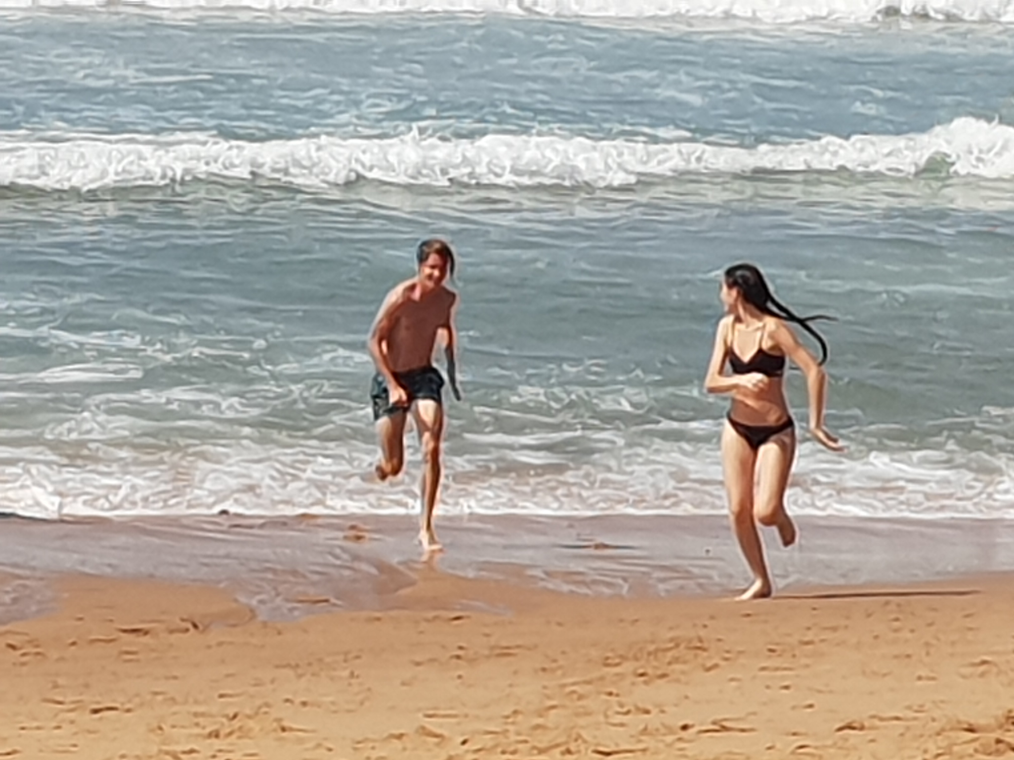 Couple running on the beach photo
