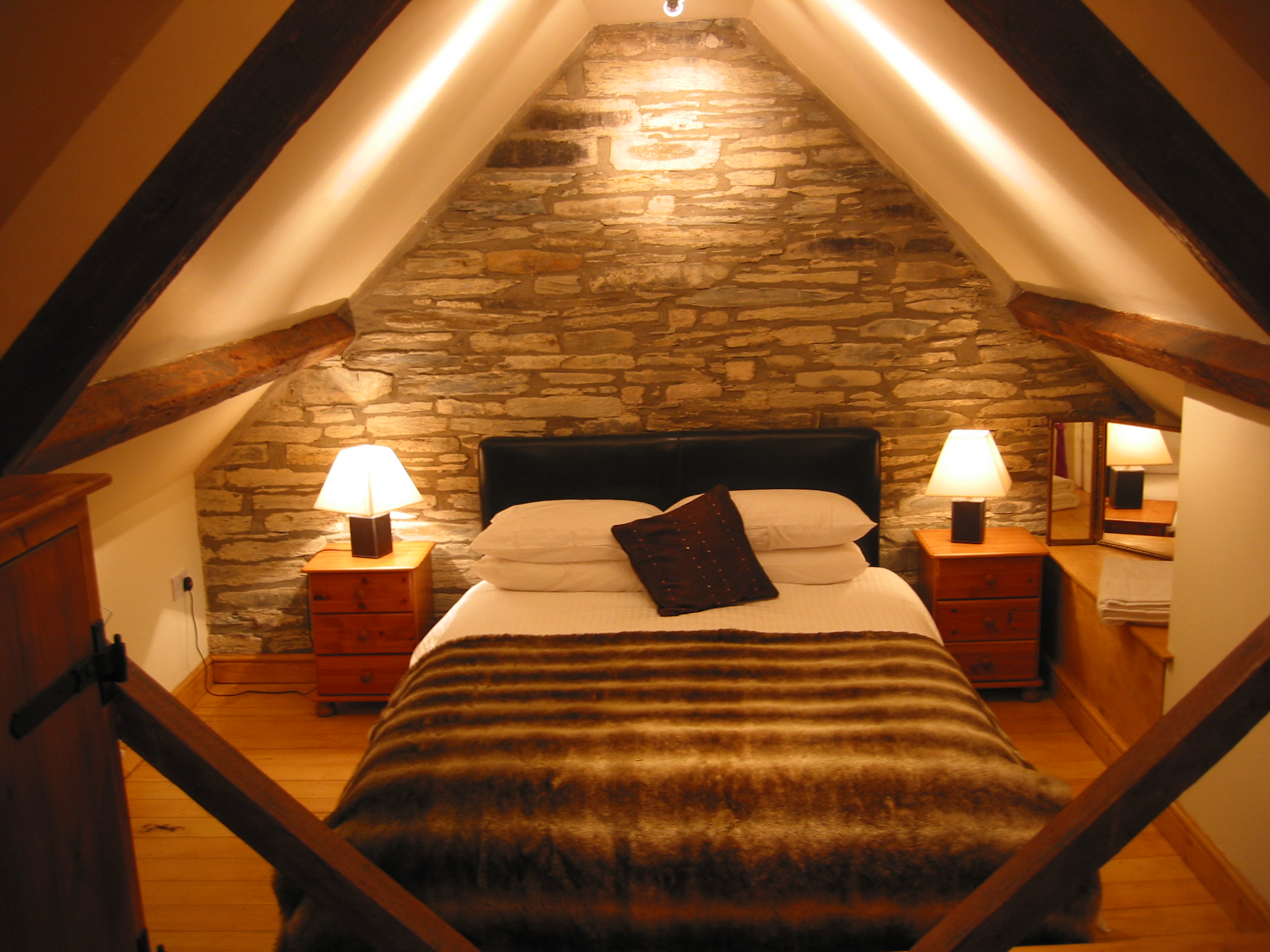 Attic Bedroom With Cozy Lighting Ceiling And Bed - Decobizz.com