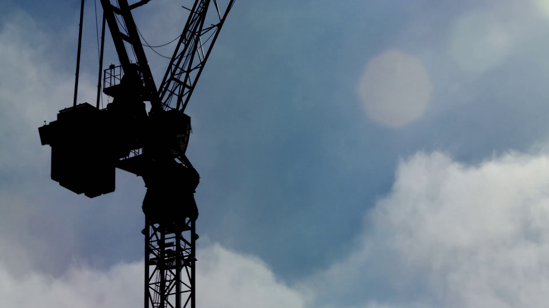 Time lapse of clouds rolling past an industrial crane during the ...