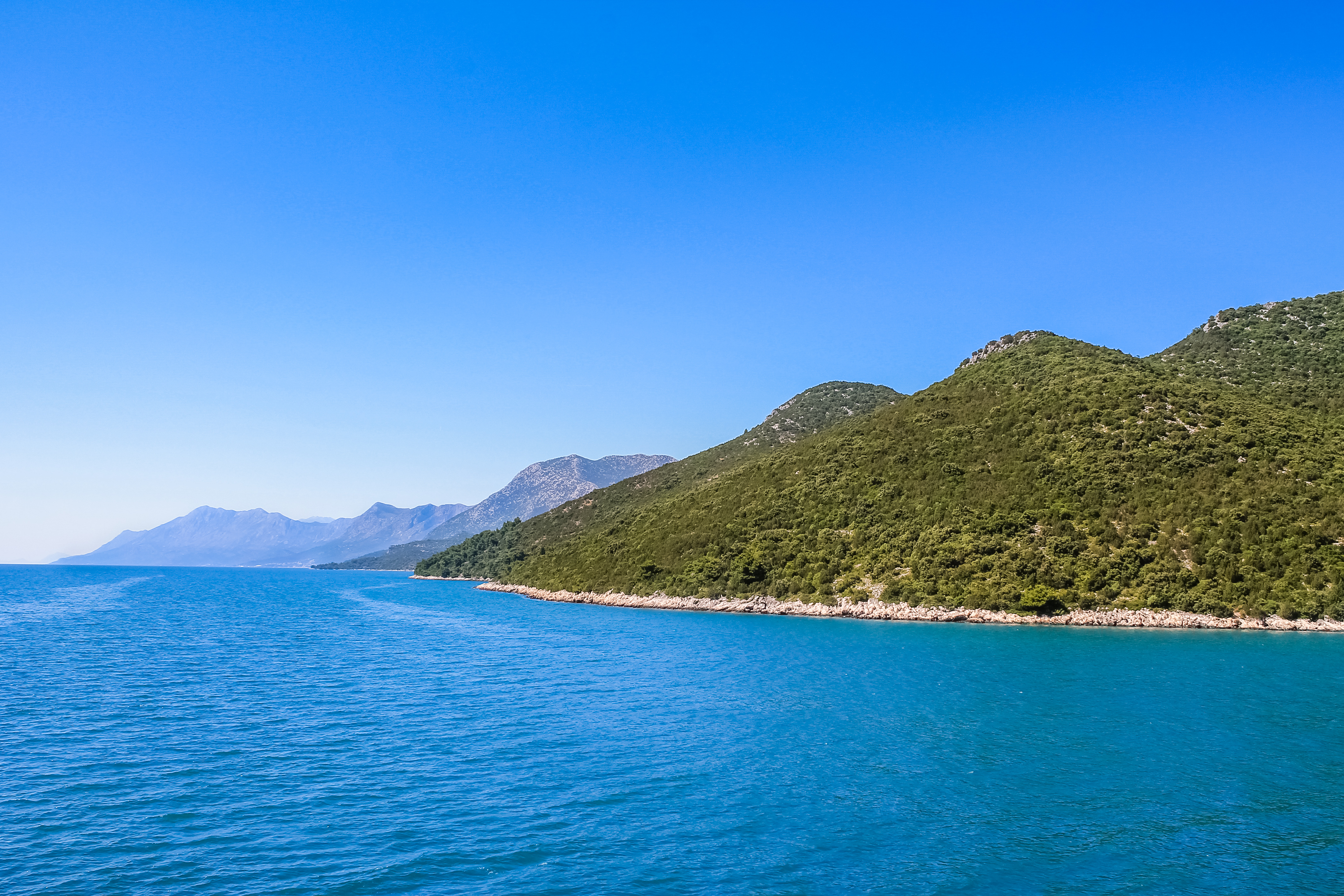 Croatian coastline with blue water and hills photo