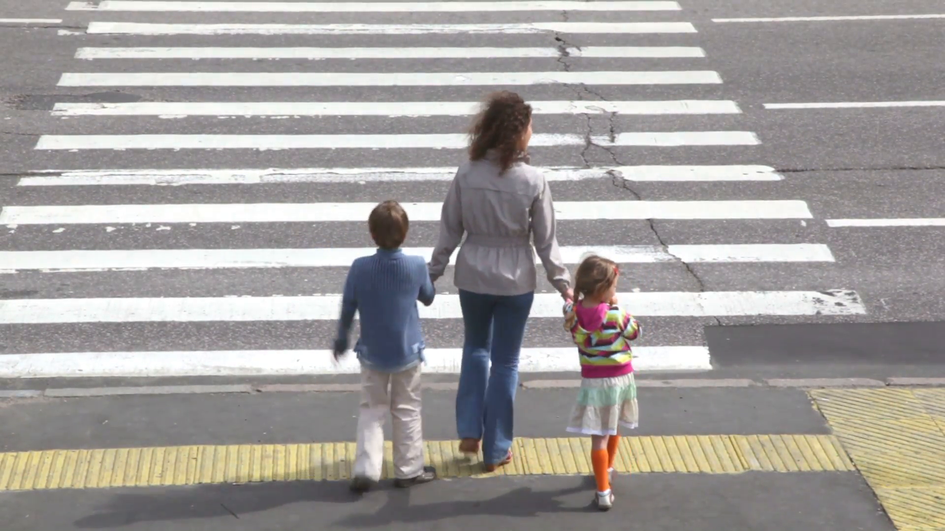 Mother and children, cross road at pedestrian crossing after car ...