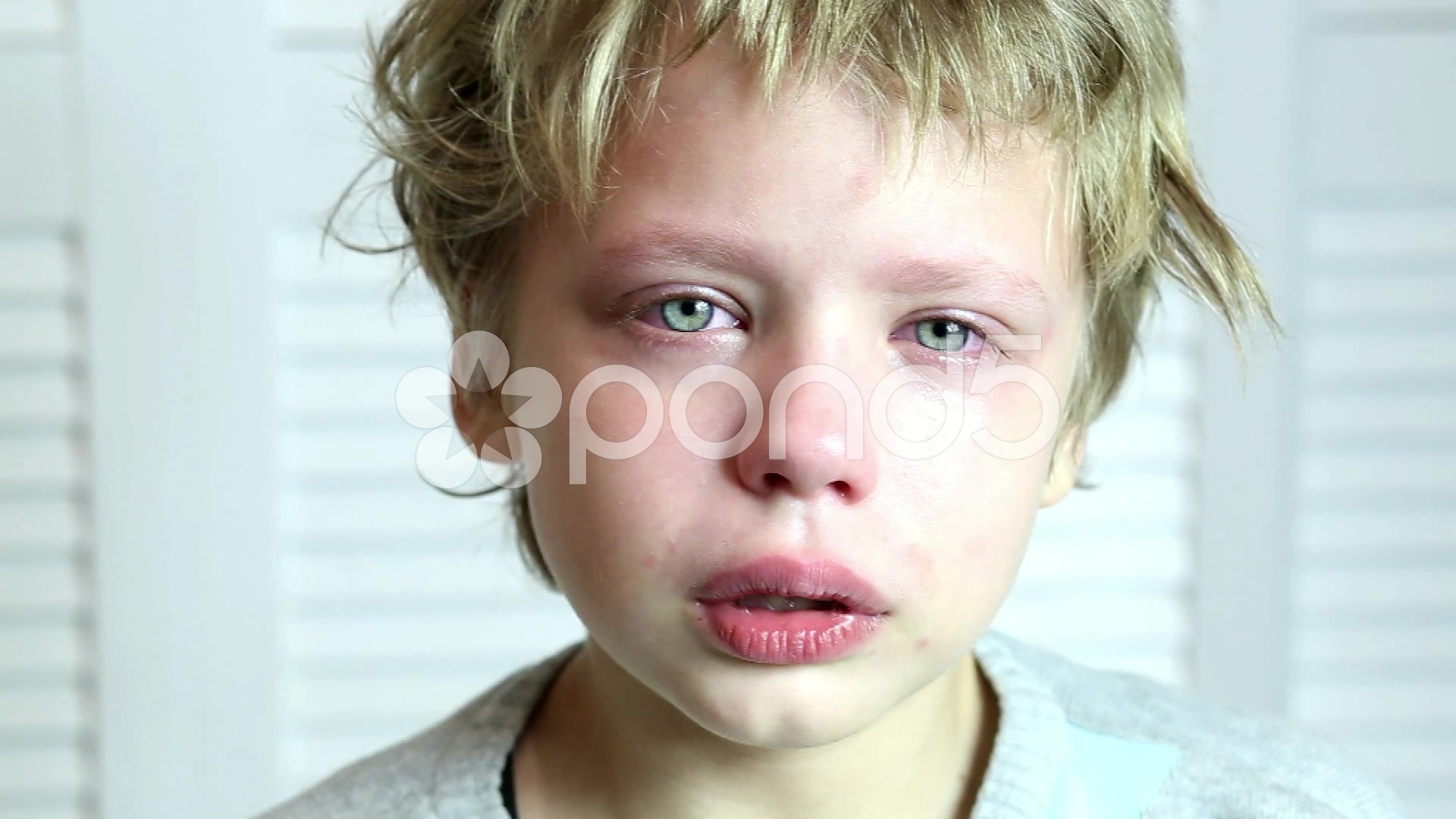 Portrait of little boy crying. eyes full of tears. close up of ...