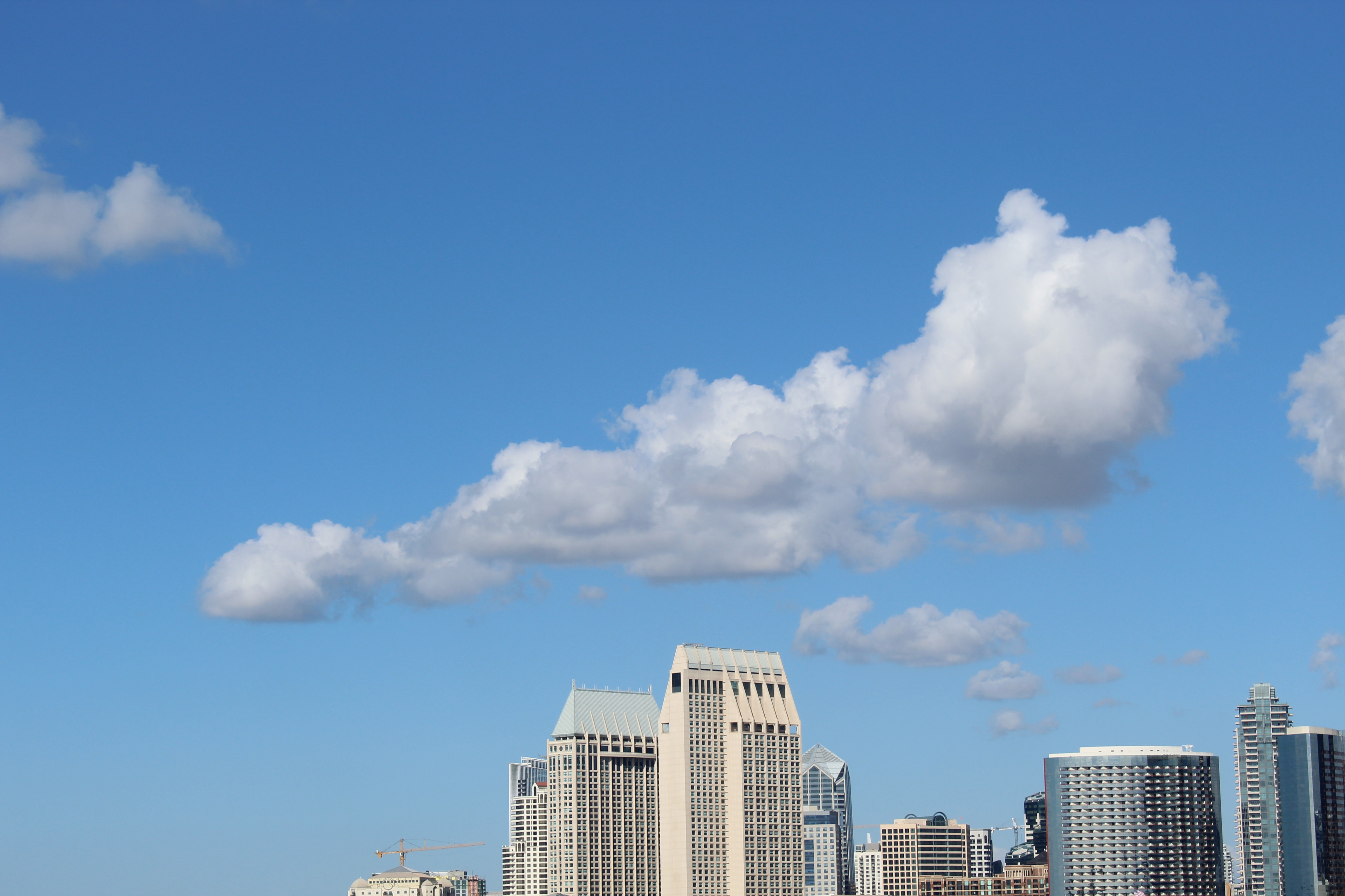 Cumulus clouds above high-rise building photo