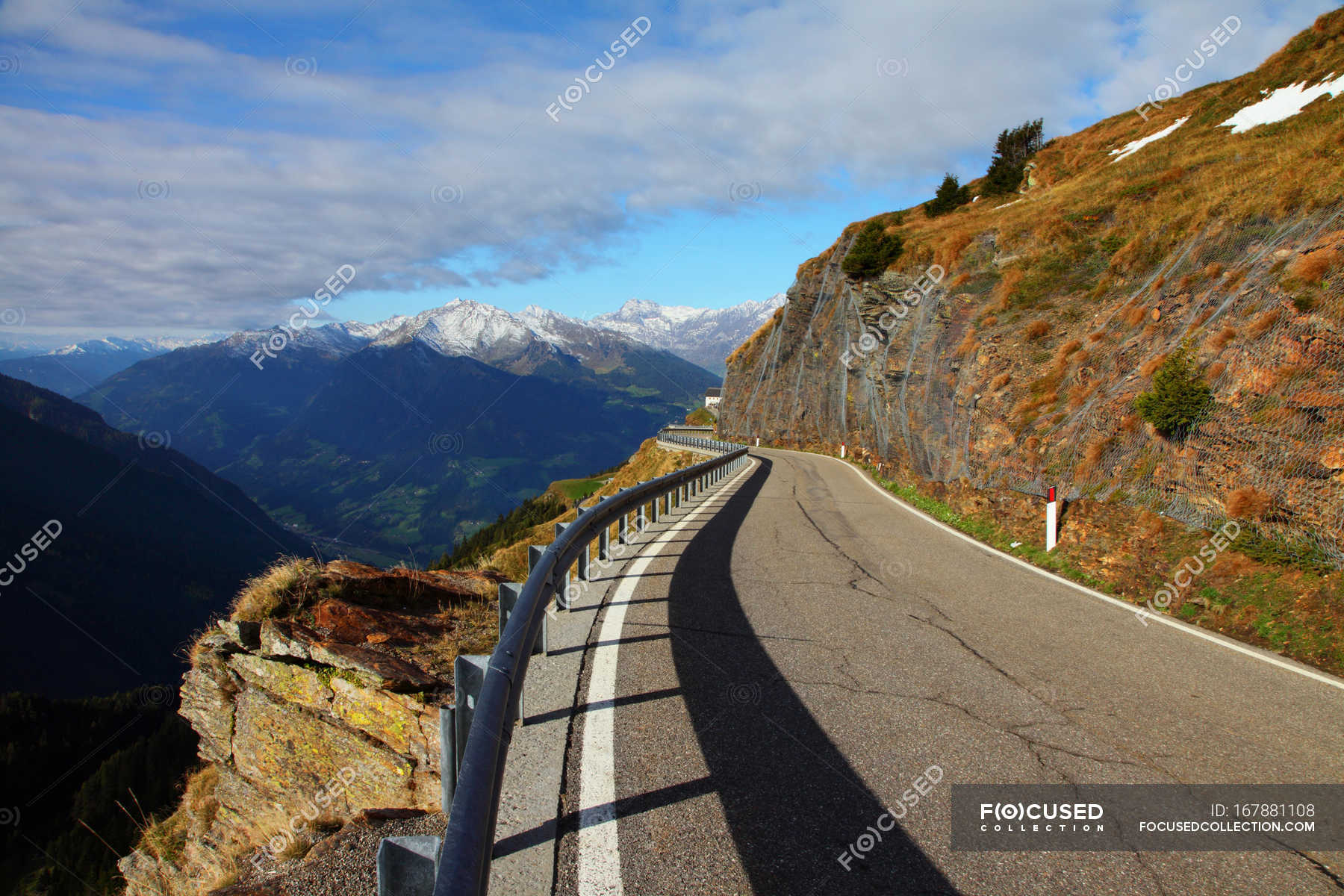 Railing along curved mountain road — Stock Photo | #167881108