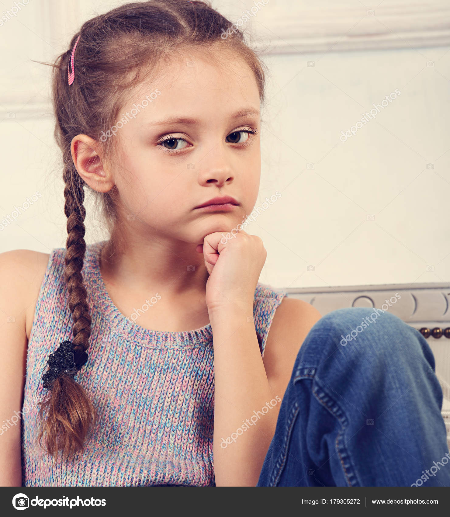 Beautiful thinking serious cute kid girl sitting on the bench in ...