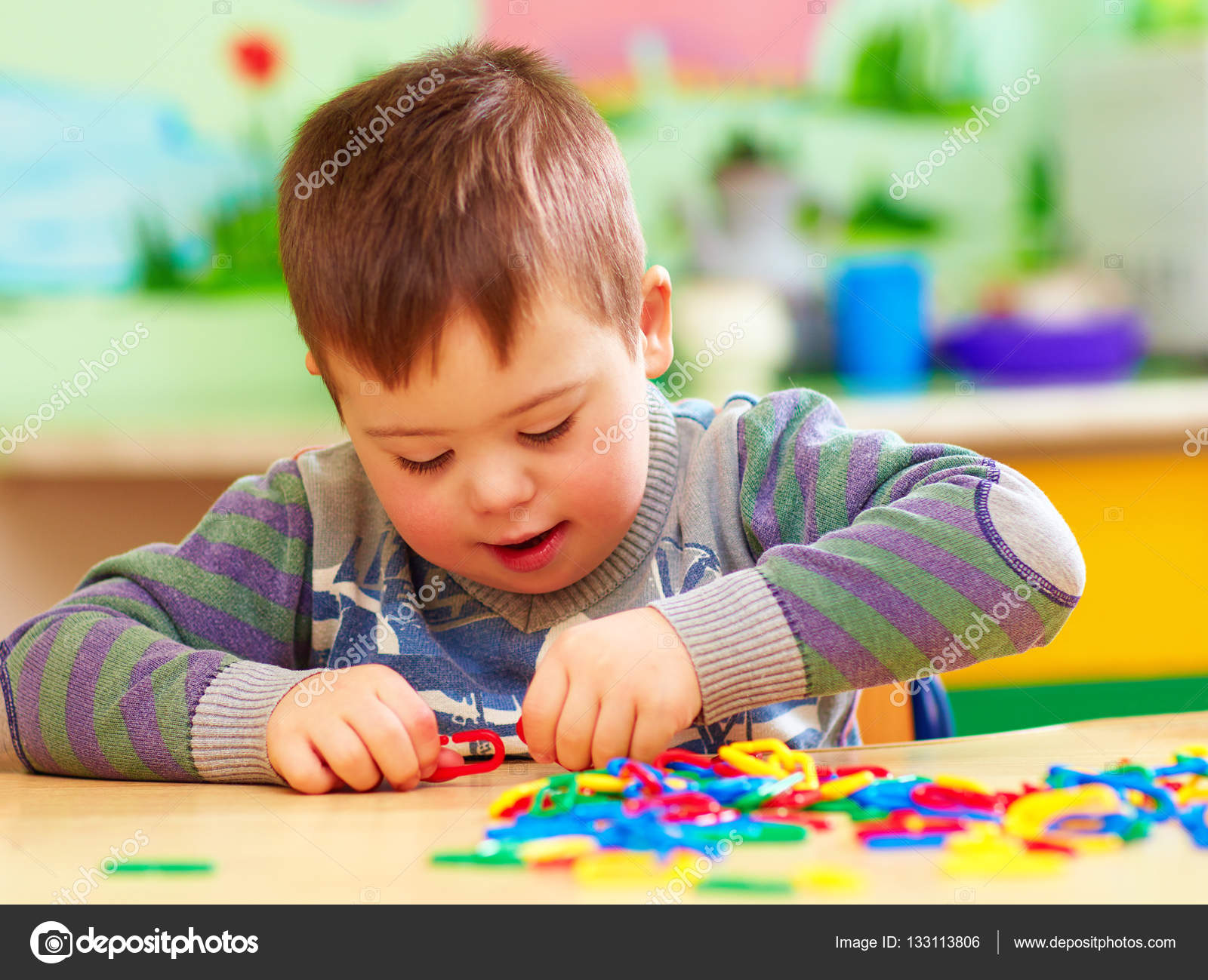 cute kid with down's syndrome playing in kindergarten — Stock Photo ...
