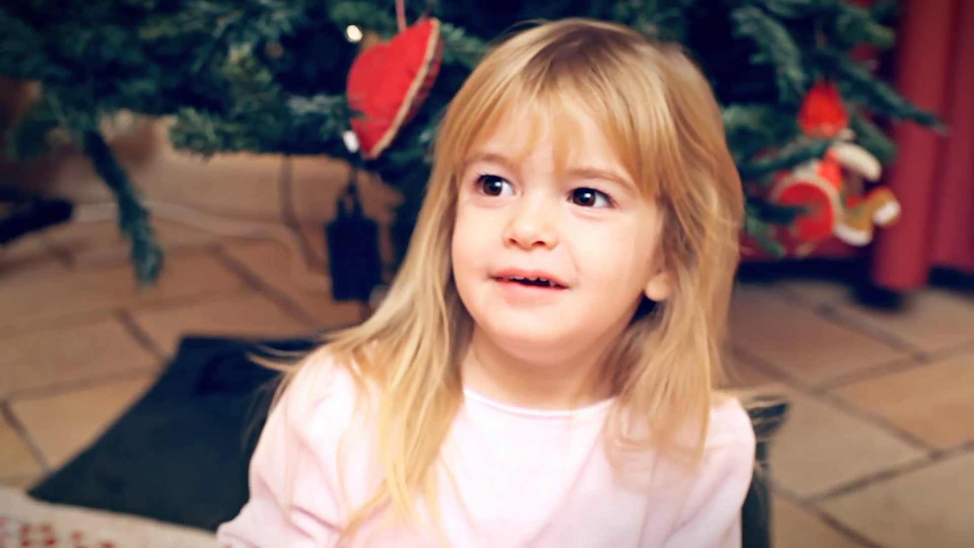 Christmas Eve little girl happy hooray. A cute little girl gets ...