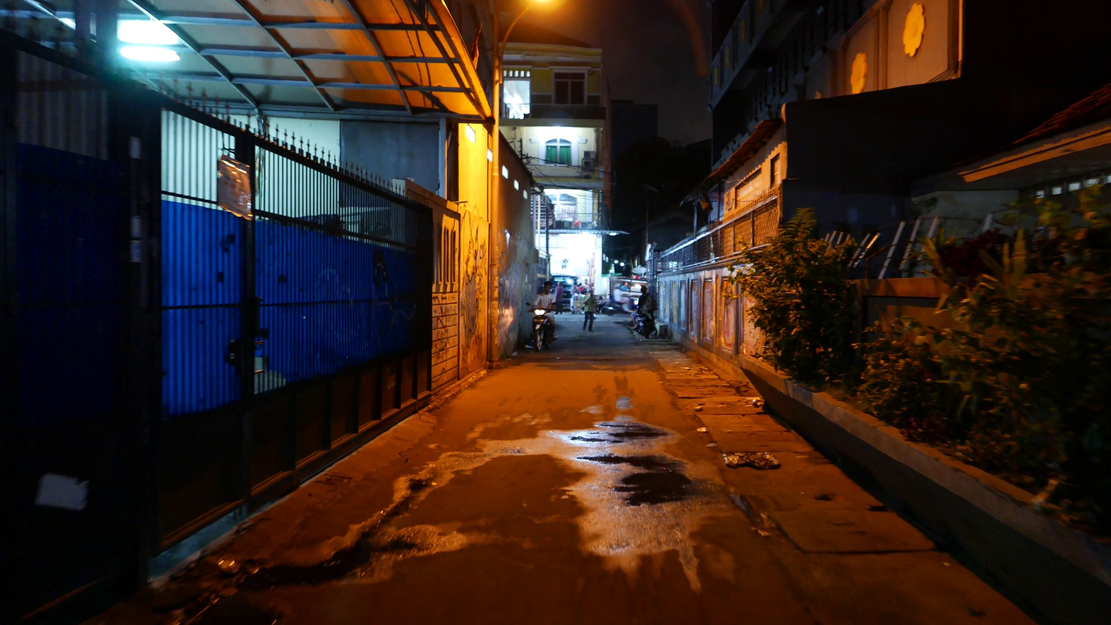Dark alley, night urban street, boy on motorbike with phone, man ...