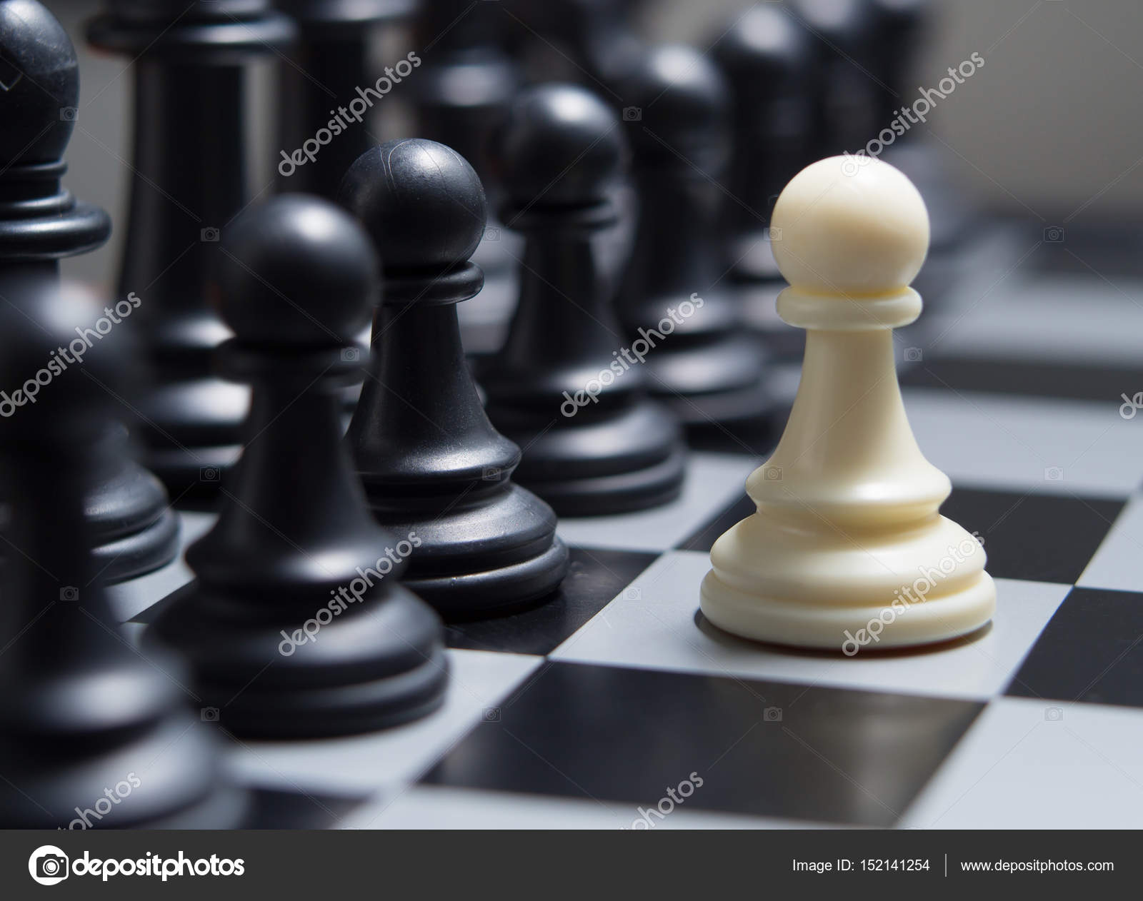 White pawn against the background of dark chess pieces — Stock Photo ...