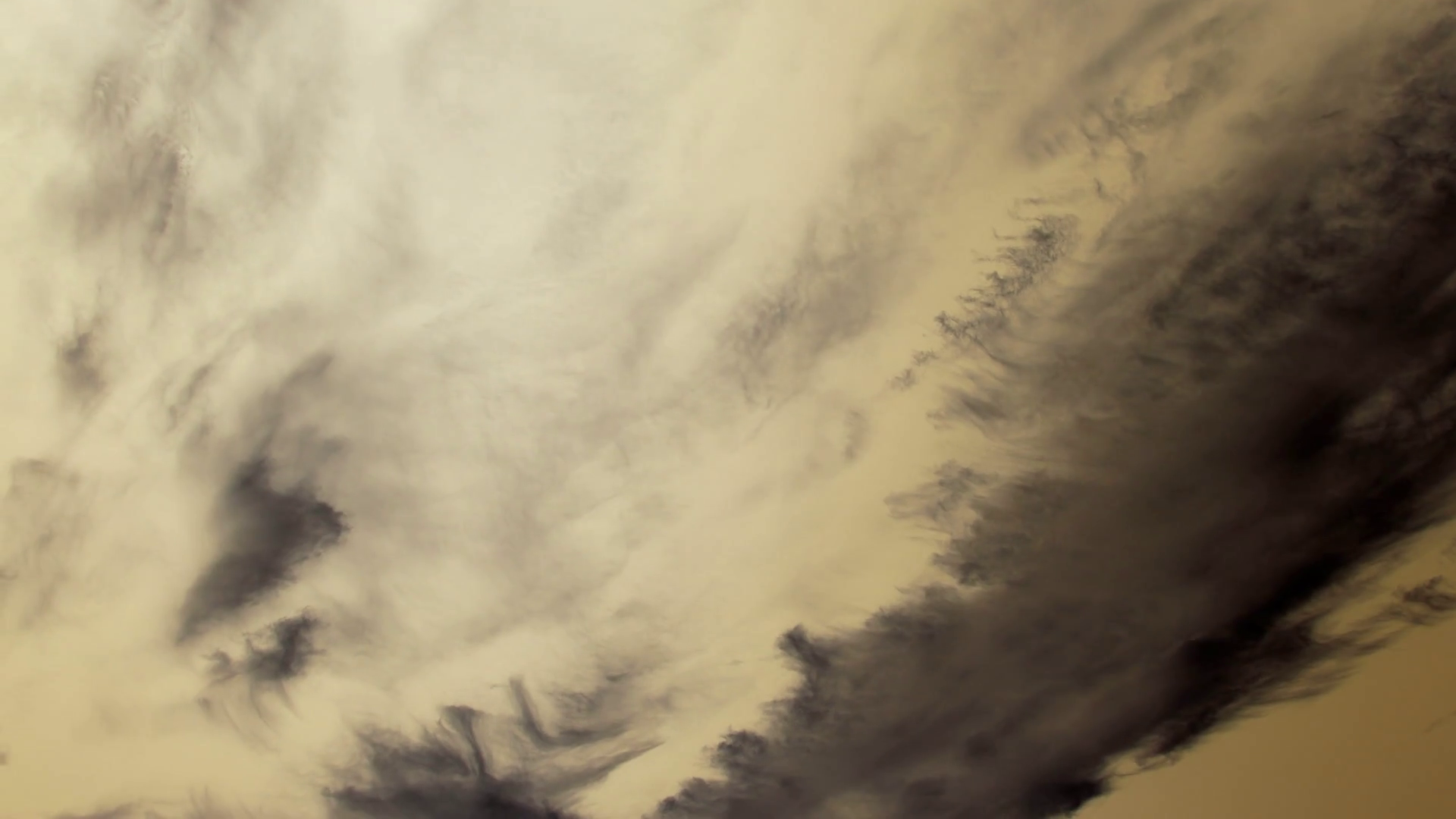 Timelapse of dark gray clouds moving fast in a sepia sky in gradient ...