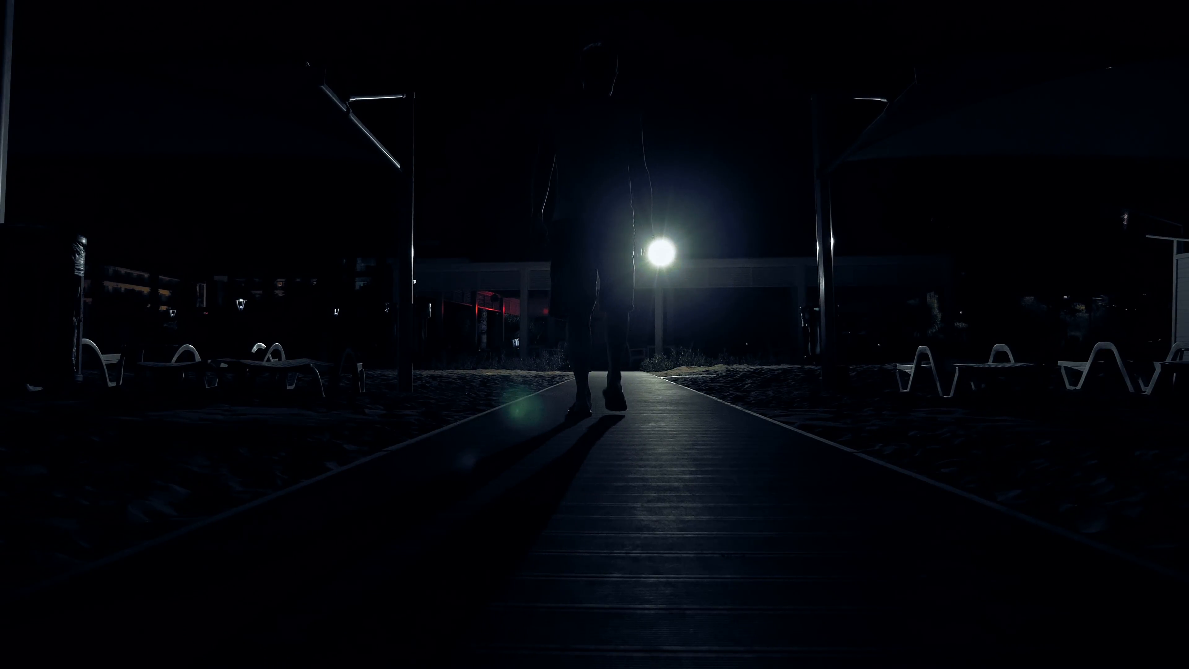 A man is walking alone in the dark out on the streets. Exploring the ...