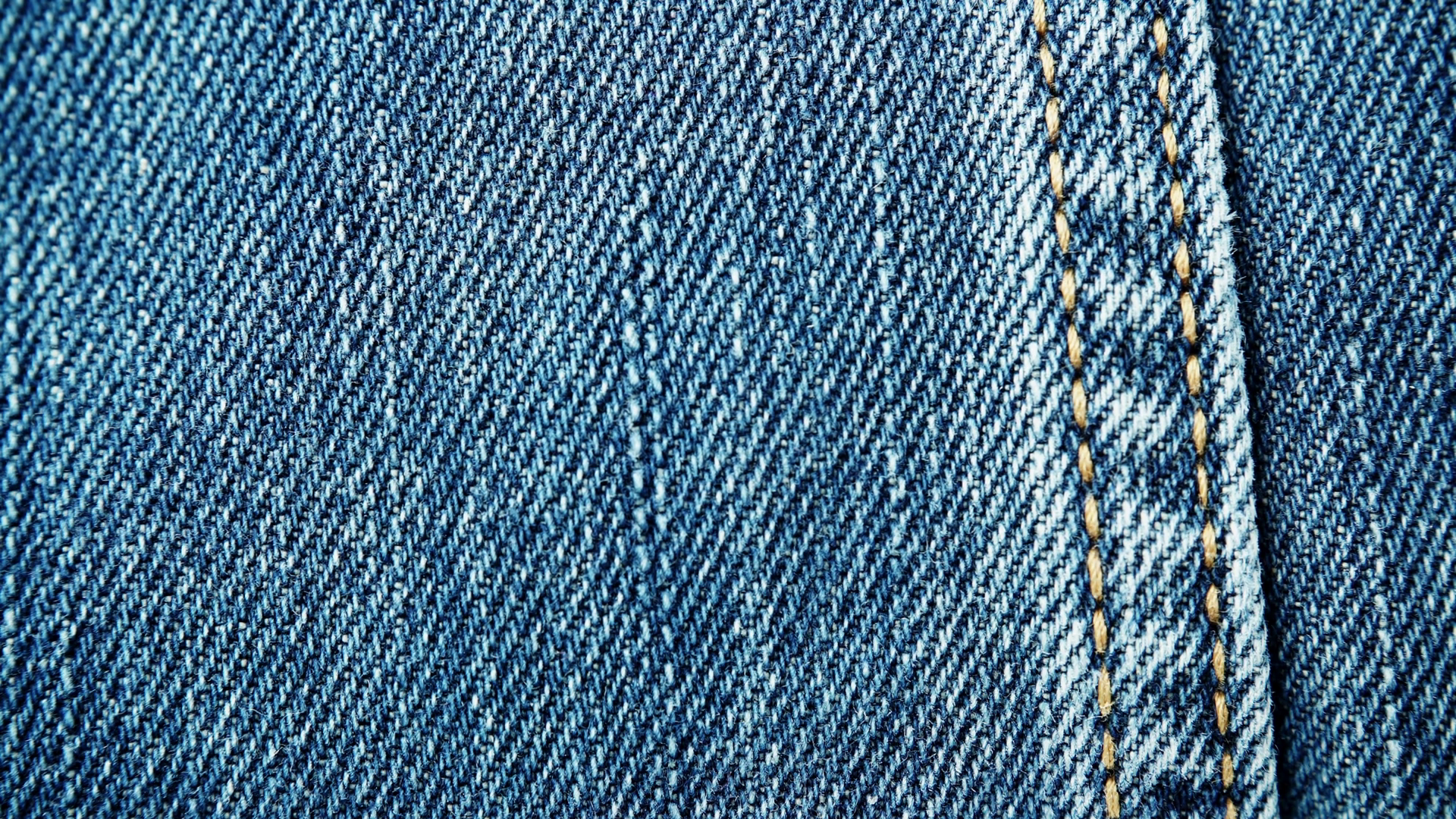 Closeup detail of blue denim jeans, texture background. Rack focus ...