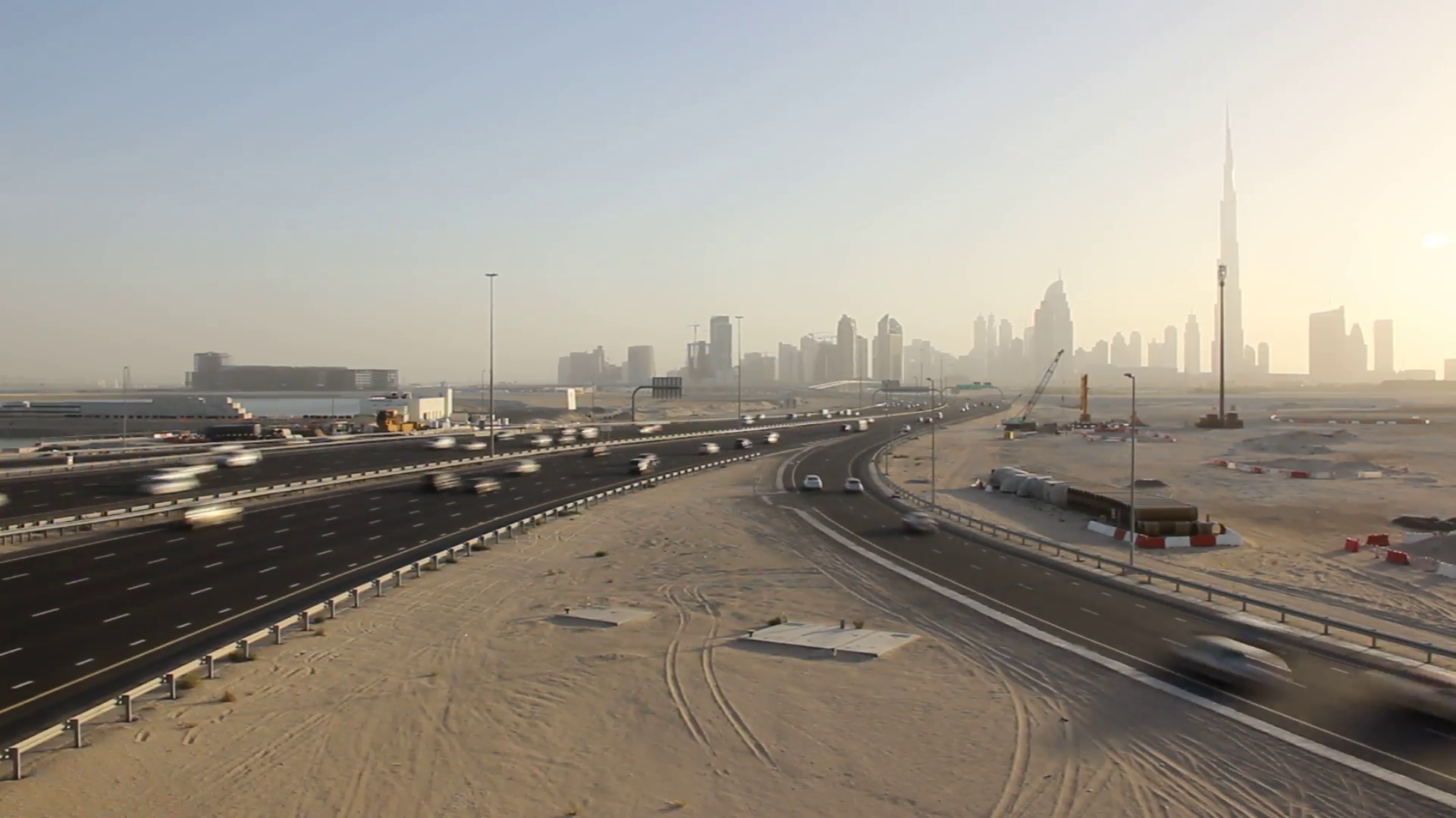 Large highway across deserted land, development area, Dubai skyline ...