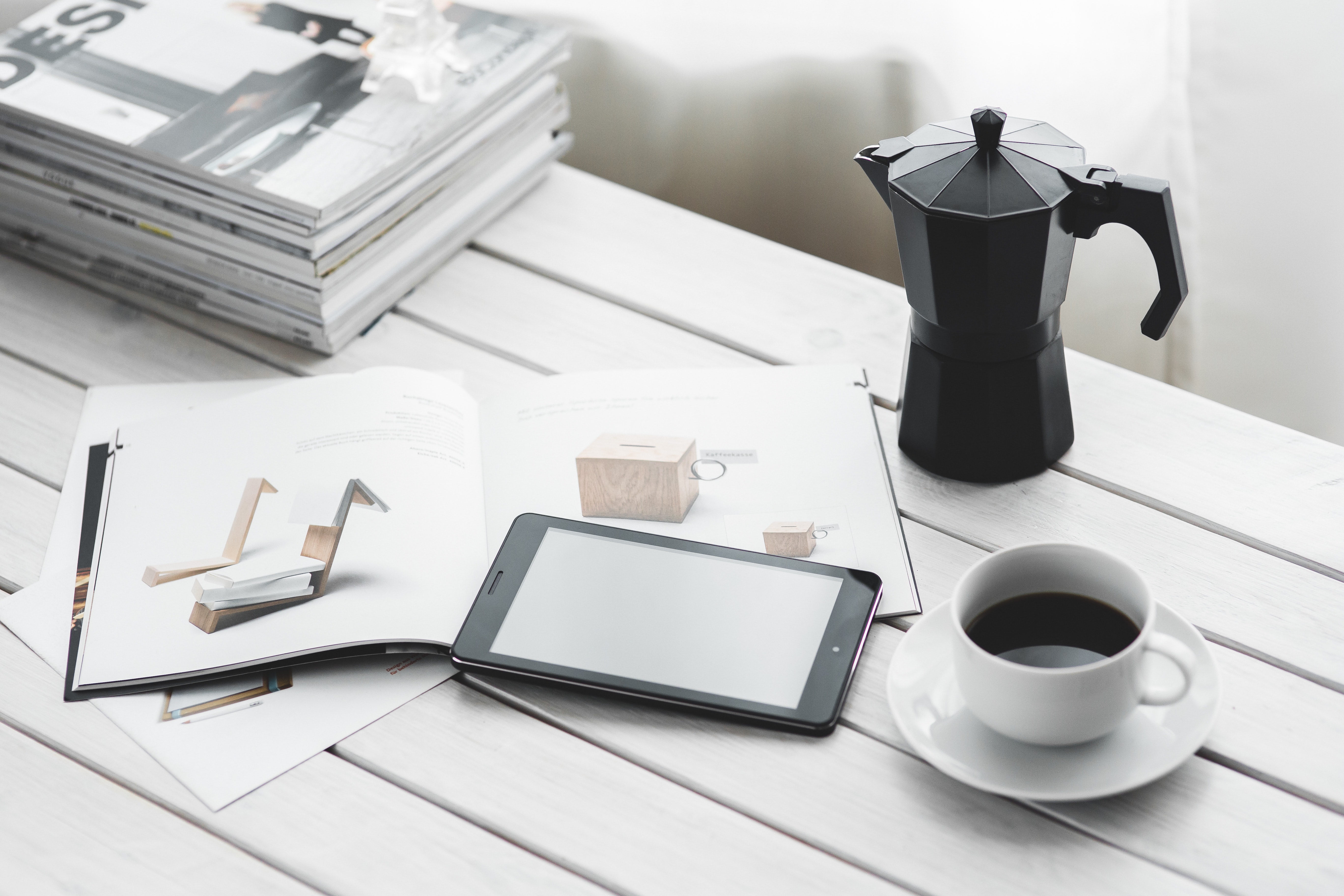 Digital tablet with cup of coffee on a white desk photo