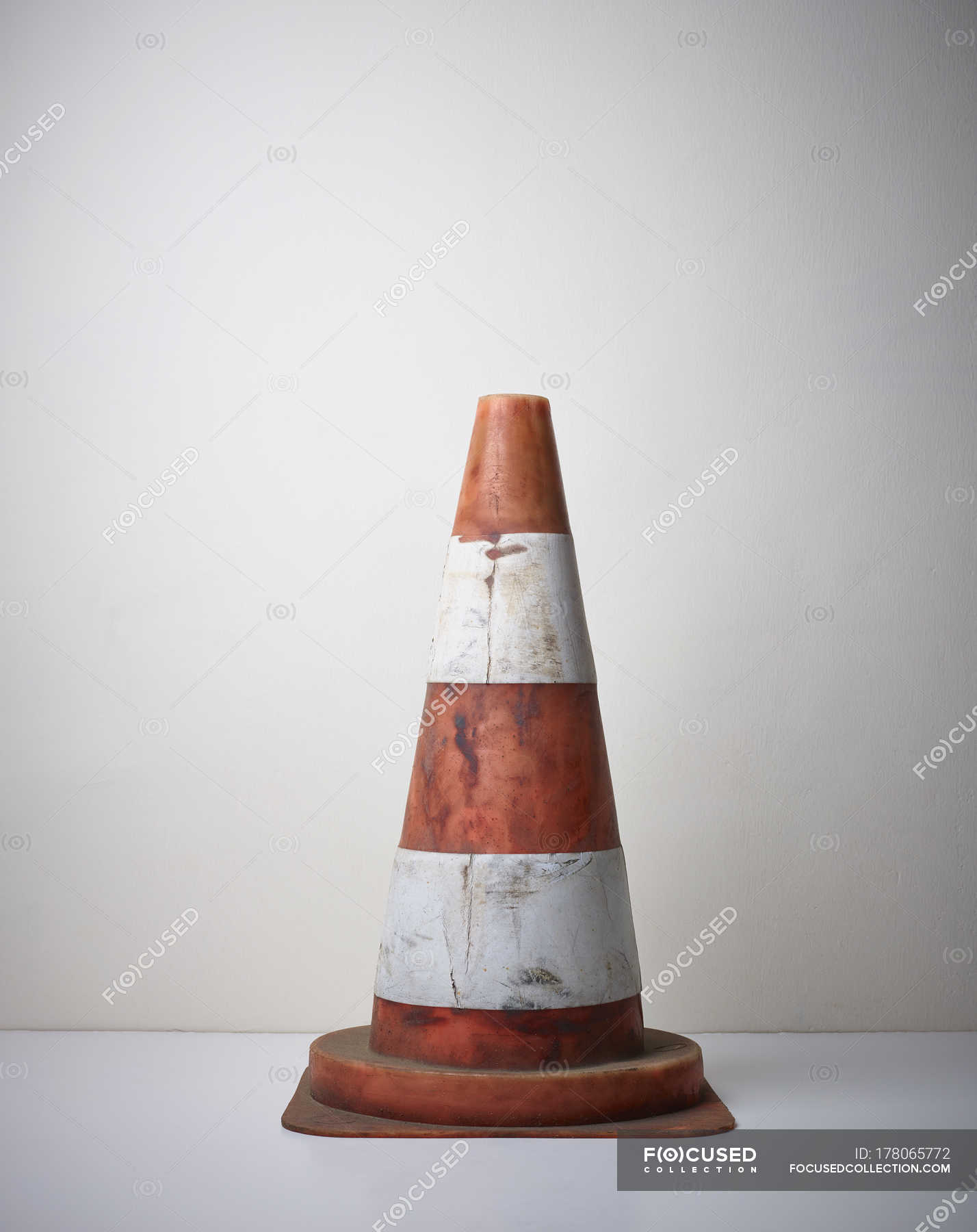 Dirty orange traffic cone on floor — Stock Photo | #178065772