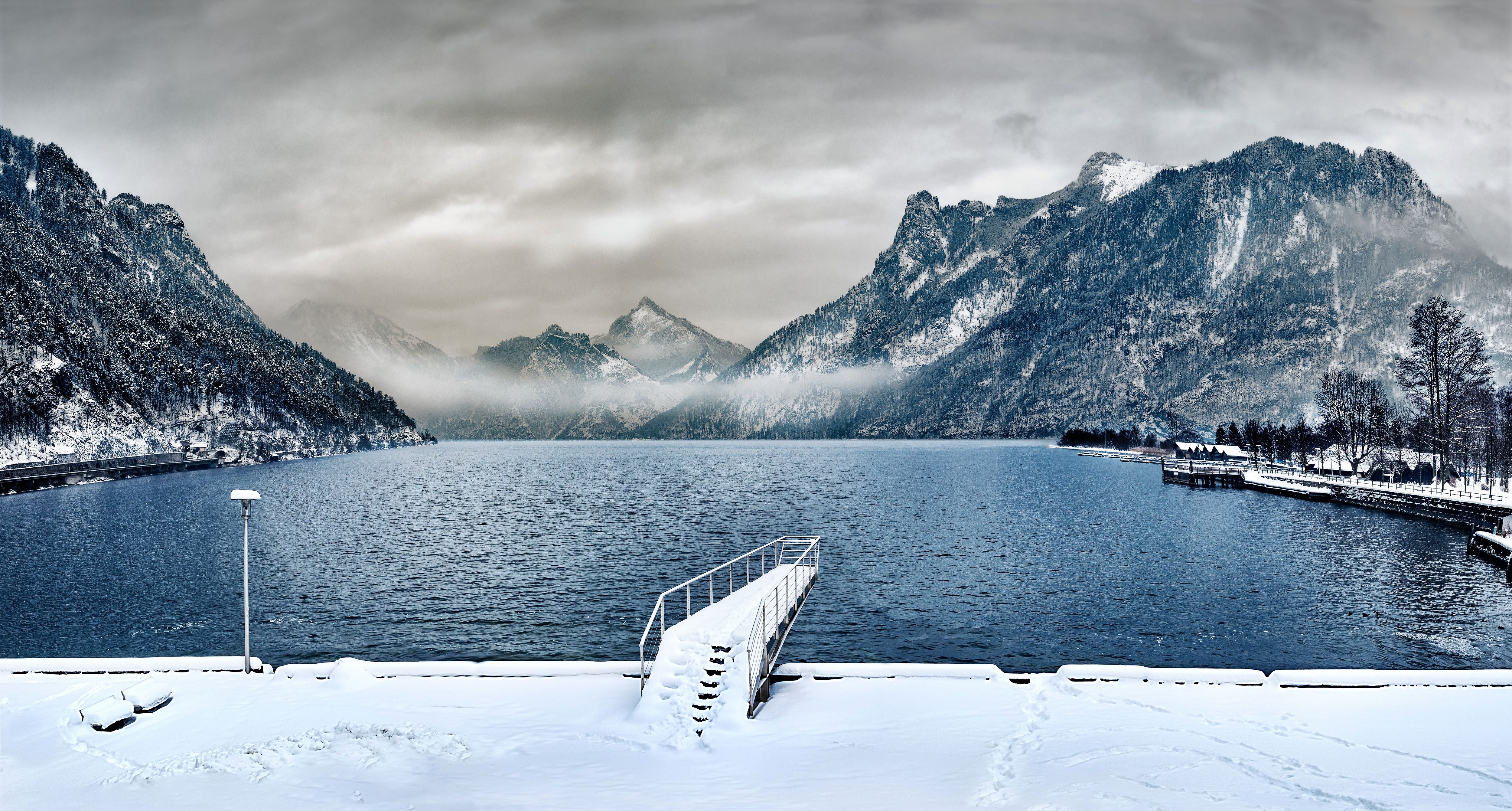 Dock covered with snow near lake photo