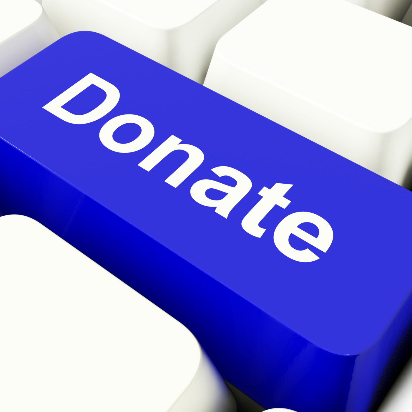 Donate computer key in blue showing charity and fundraising photo