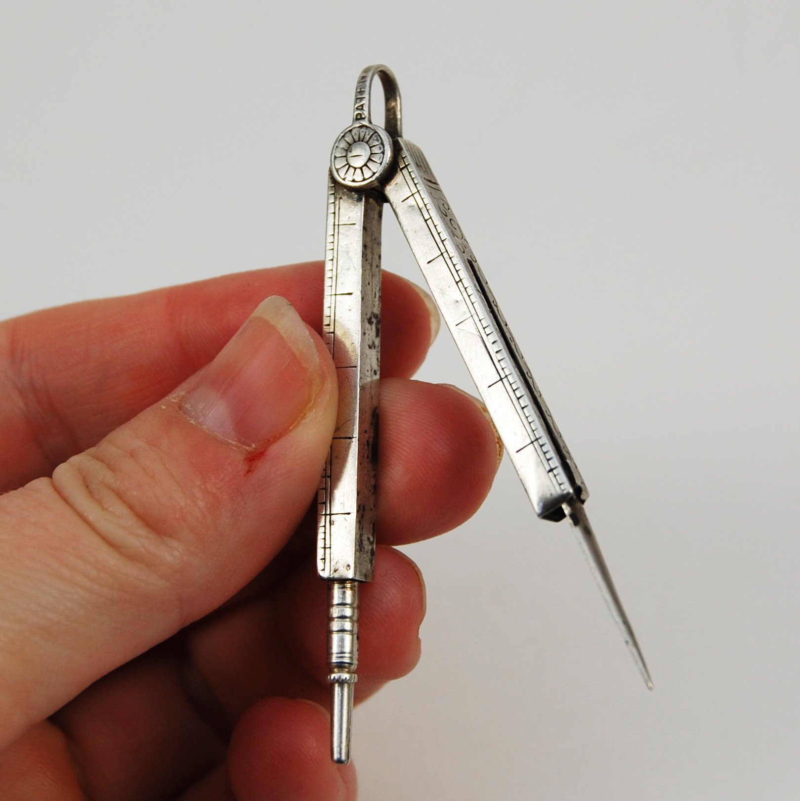 Miniature silver drawing compass | Alembic Rare Books