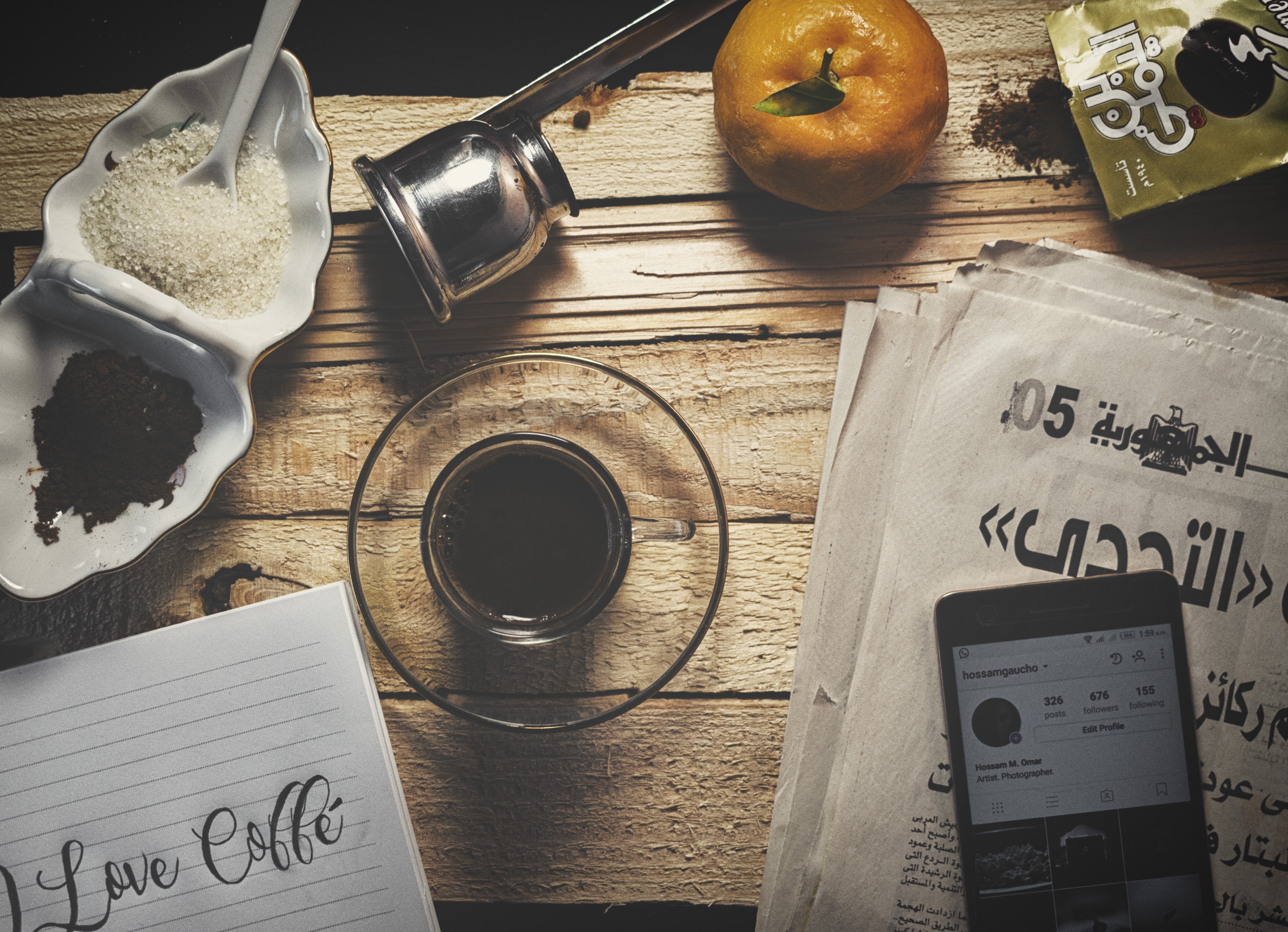 Drinking Glass on Brown Wooden Table, Black coffee, Newspaper, Sugar, Spoon, HQ Photo