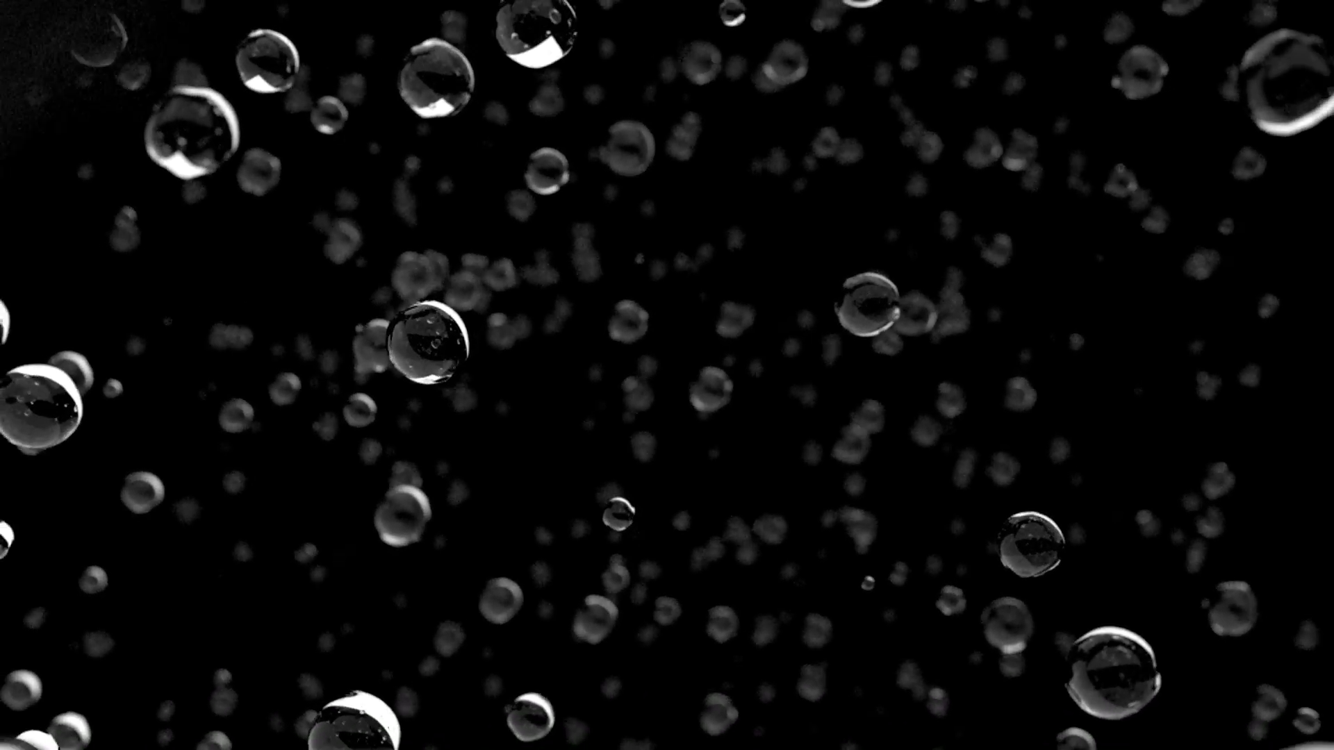 Rain water droplets close up falling away from camera DOF slow ...