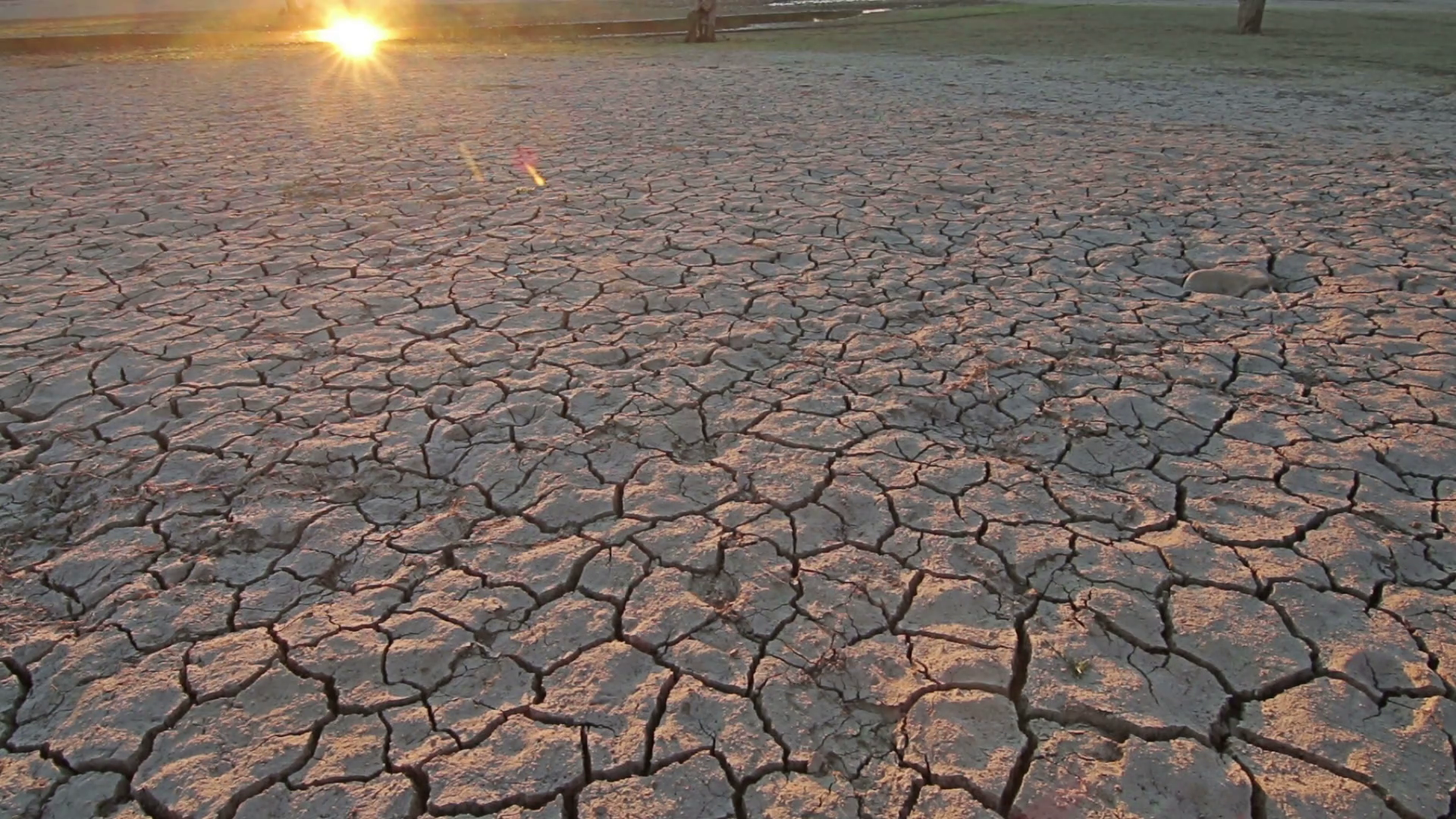 Sunset above drought disaster, dry soil. Climate change, global ...